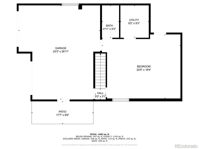 Floor plan showing a large garage, bedroom, bath, utility room, hall, and patio.