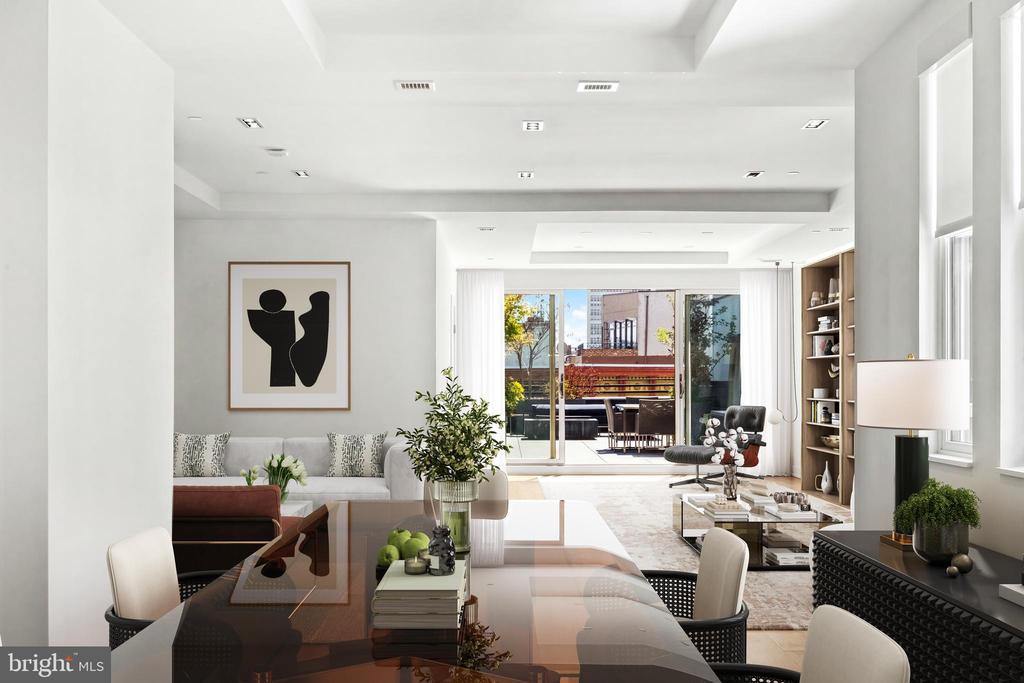 Open-plan living and dining room with neutral furnishings and sliding doors to a city-facing terrace.