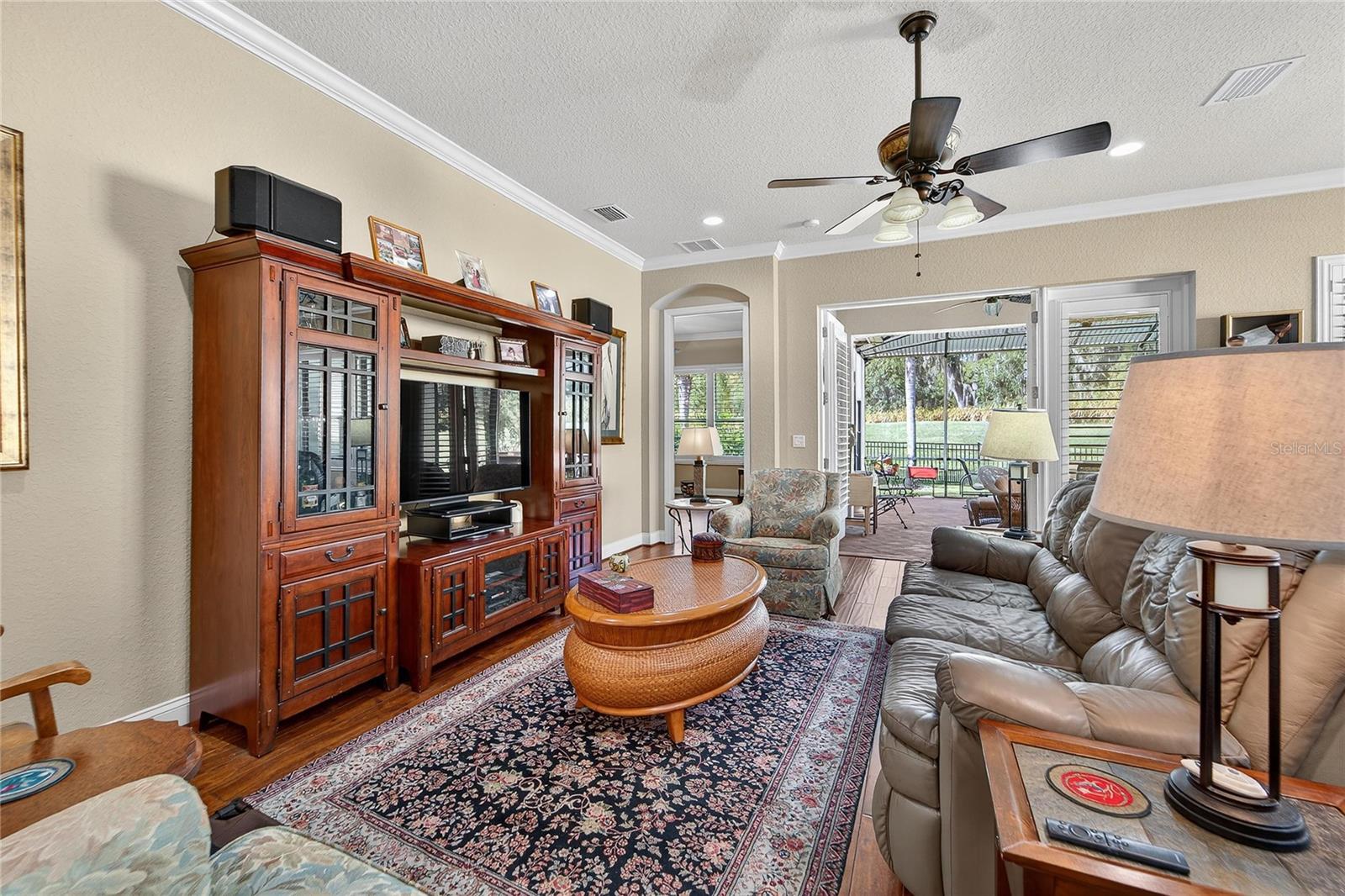 Spacious living room with crown molding and large windows