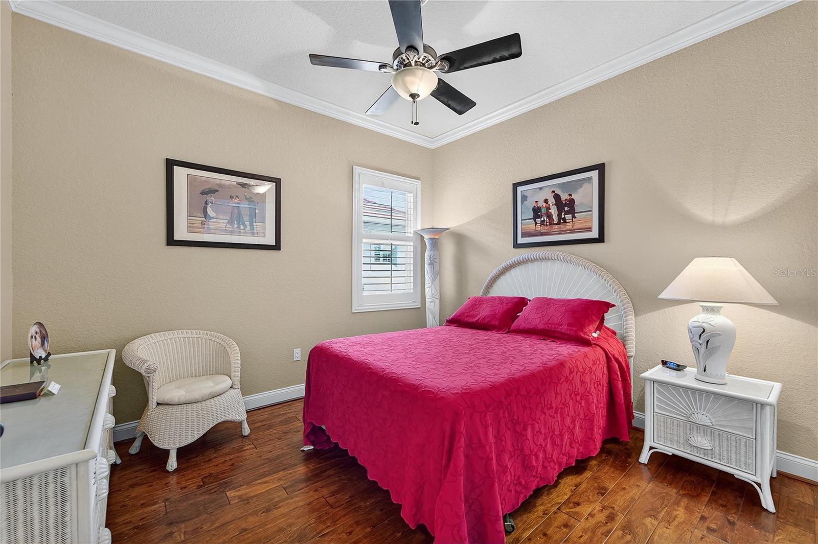 Guest bedroom with built-in closet and wood flooring