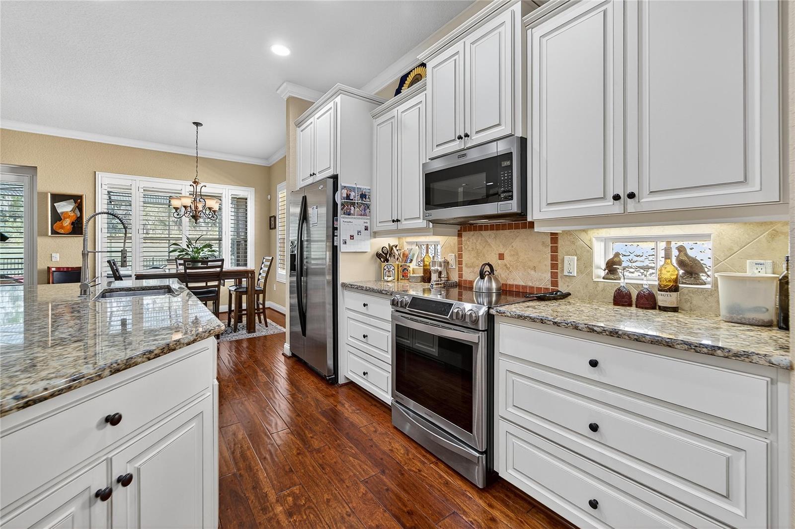 Stainless steel appliances and tile backsplash in kitchen