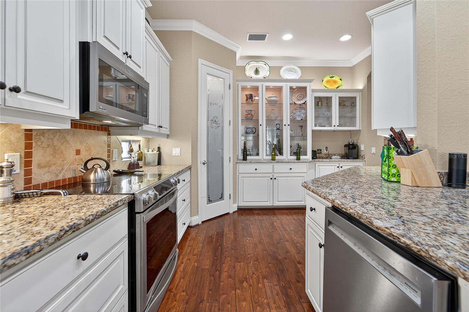 Gourmet kitchen with stone countertops and custom cabinetry