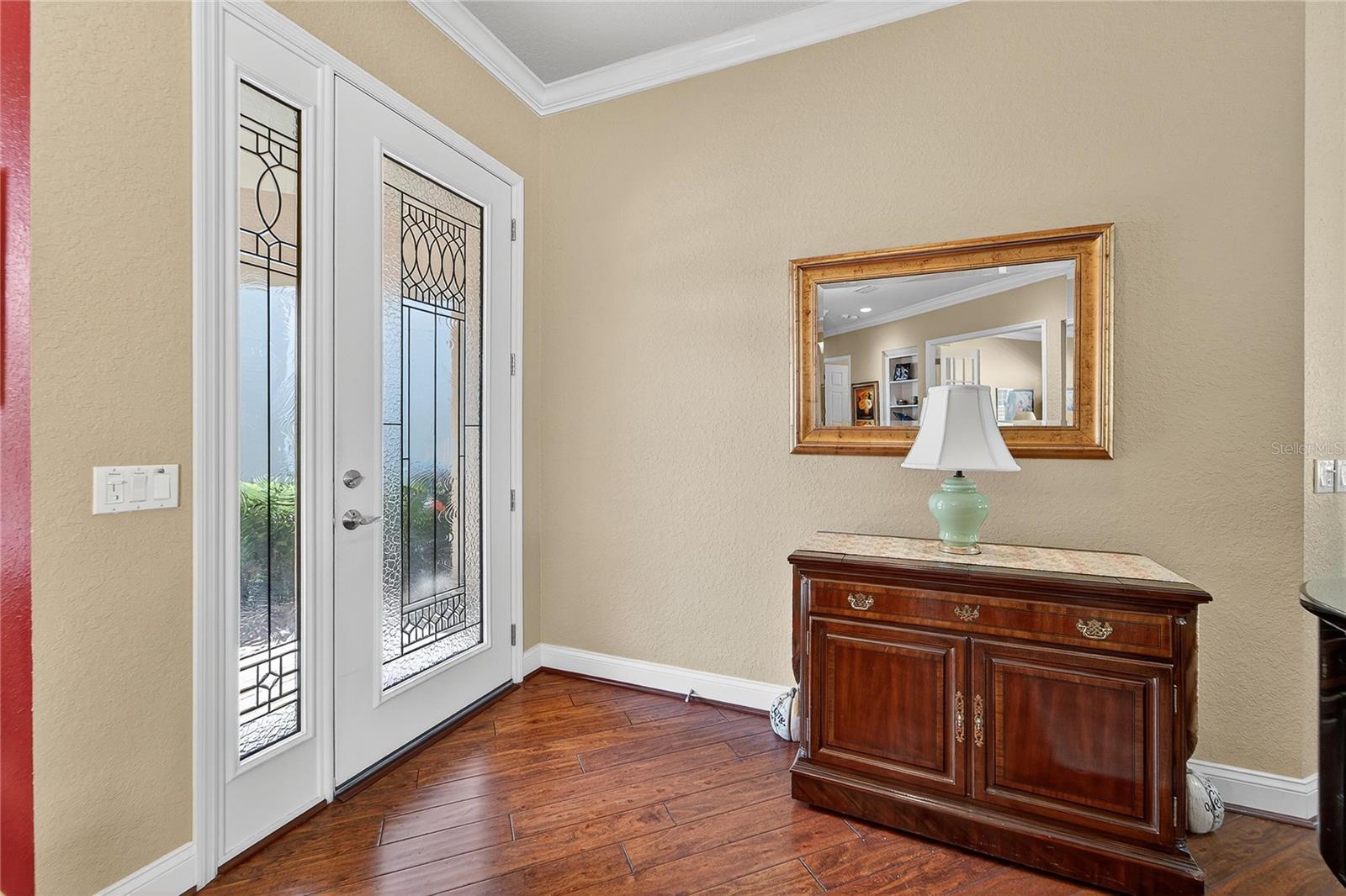 Front entryway with high ceilings and decorative molding
