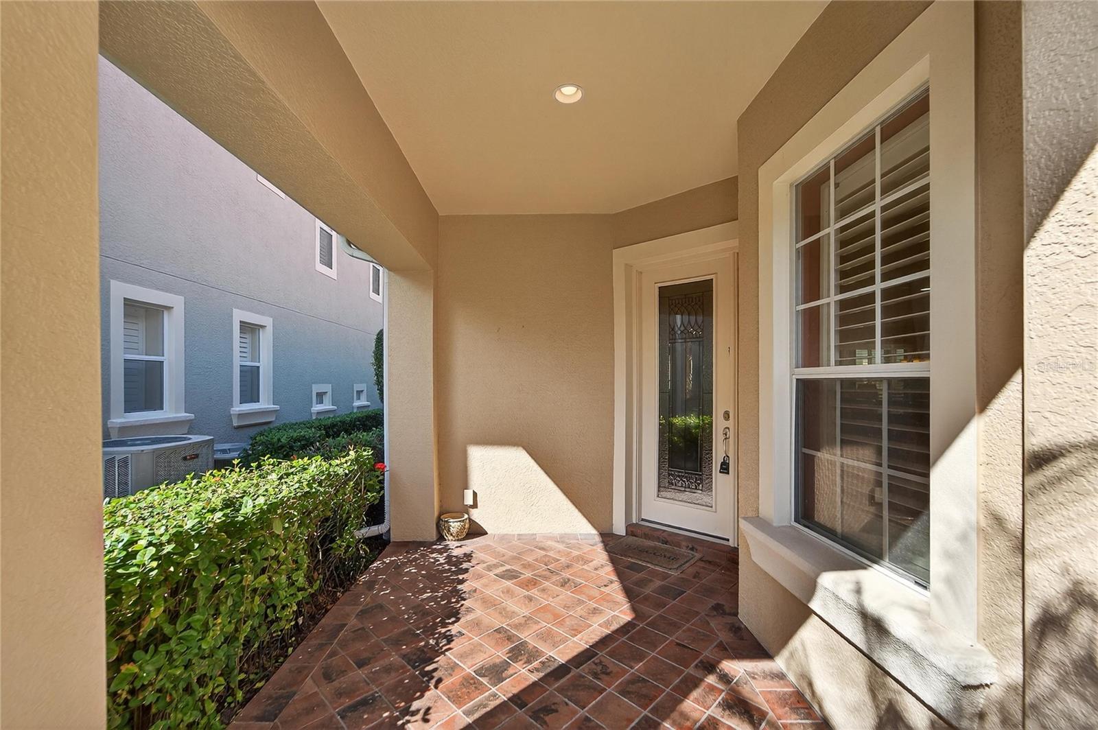Front porch entryway with decorative glass door