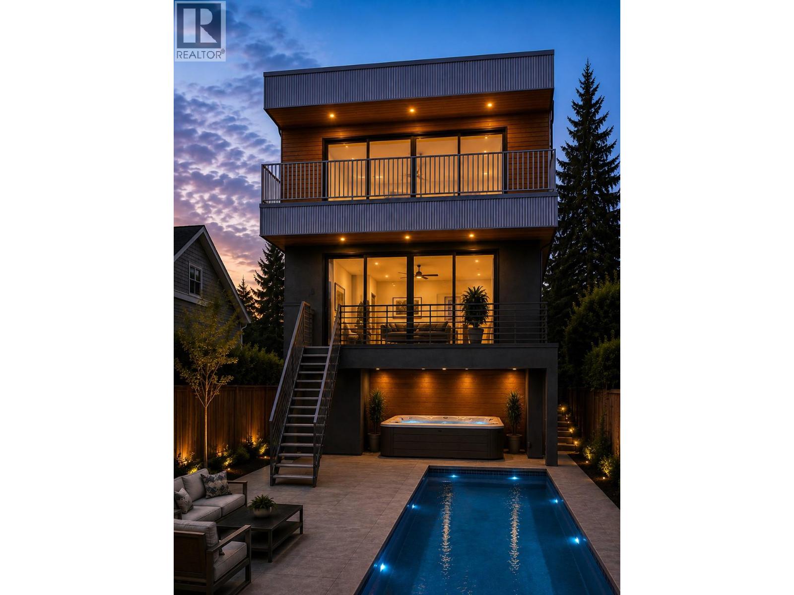 Modern multi-story home at dusk, with illuminated balconies, a backyard pool, and a hot tub.