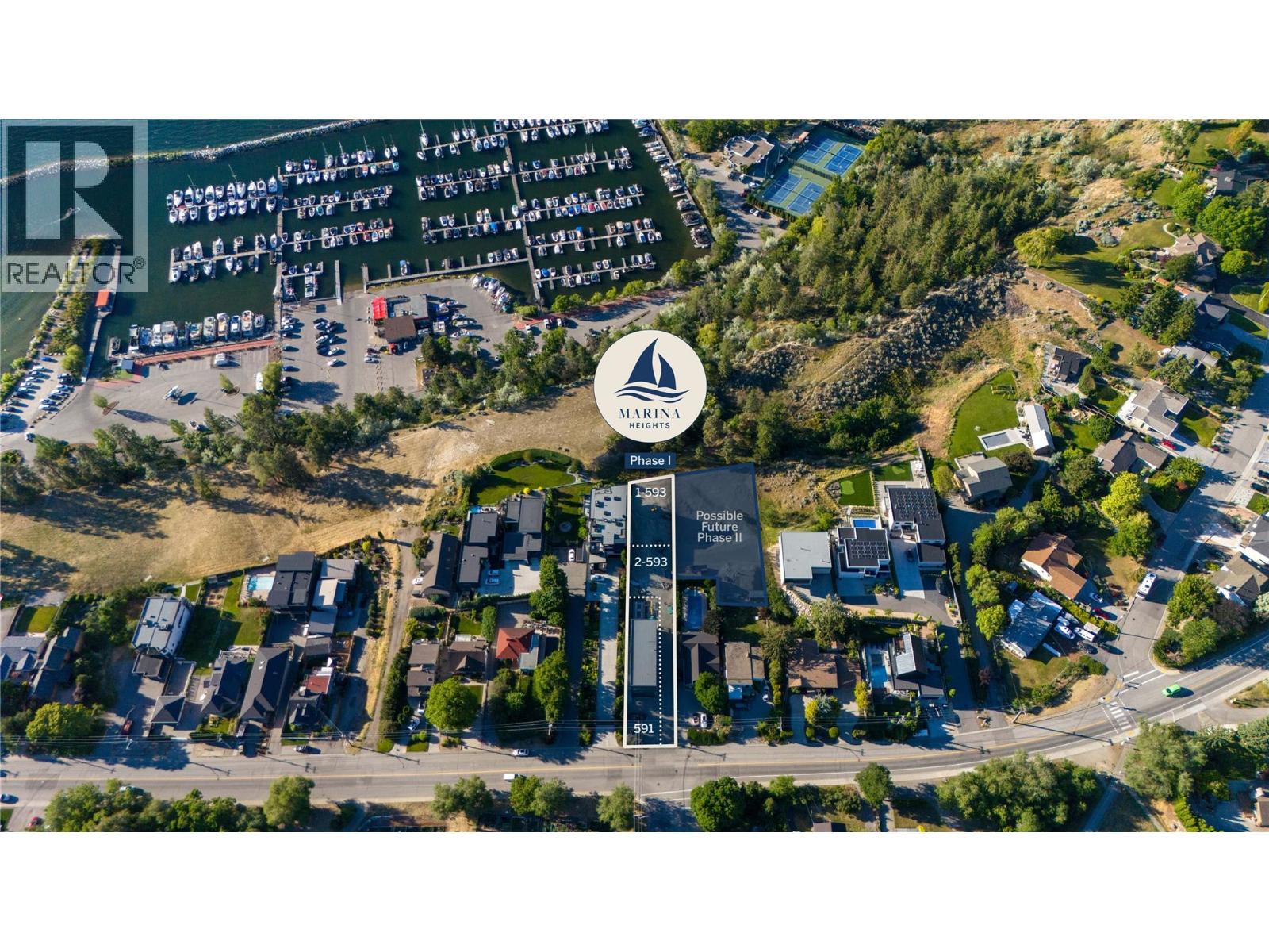 Aerial view of a marked Marina Heights parcel beside the marina and surrounding homes.