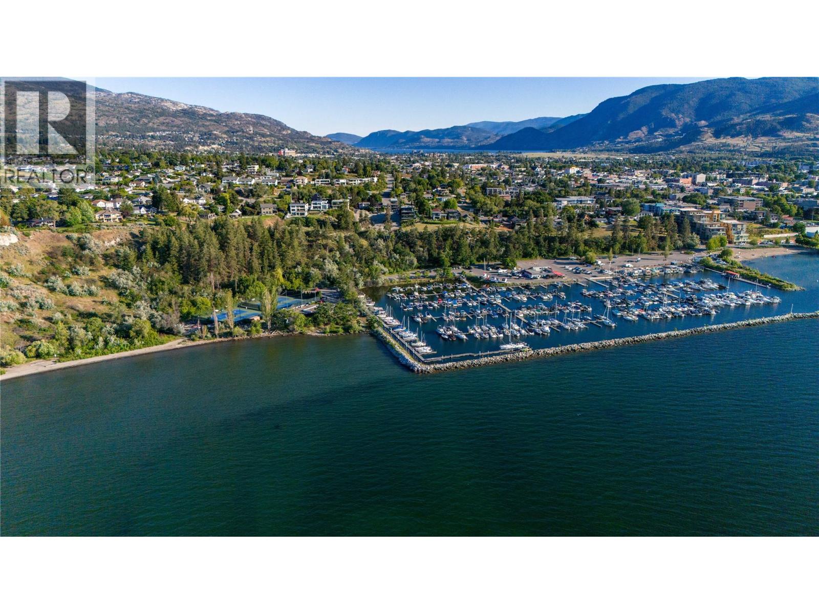 Aerial view of Penticton’s marina and waterfront, with the city and mountains beyond.