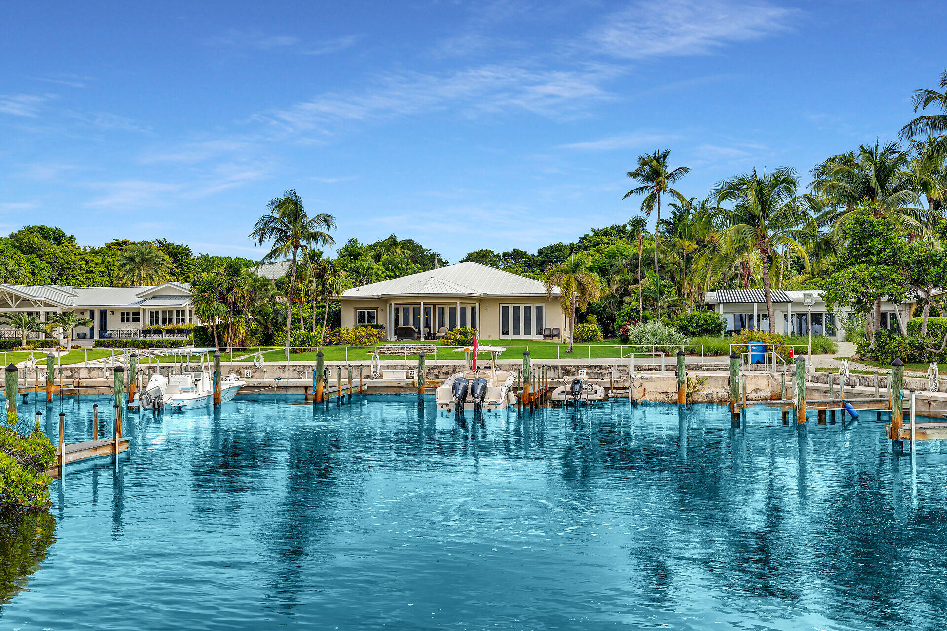 Palm-lined waterfront homes and private docks along a blue canal in Islamorada.