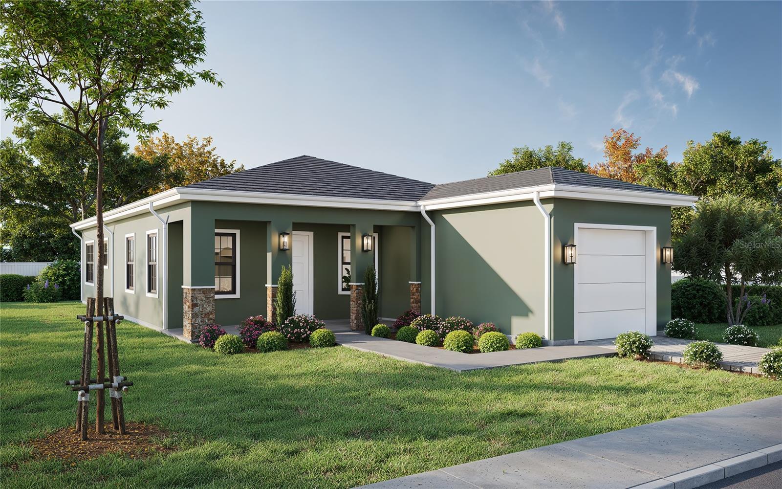 Single-story green home with a covered entry, attached garage, and landscaped front lawn.