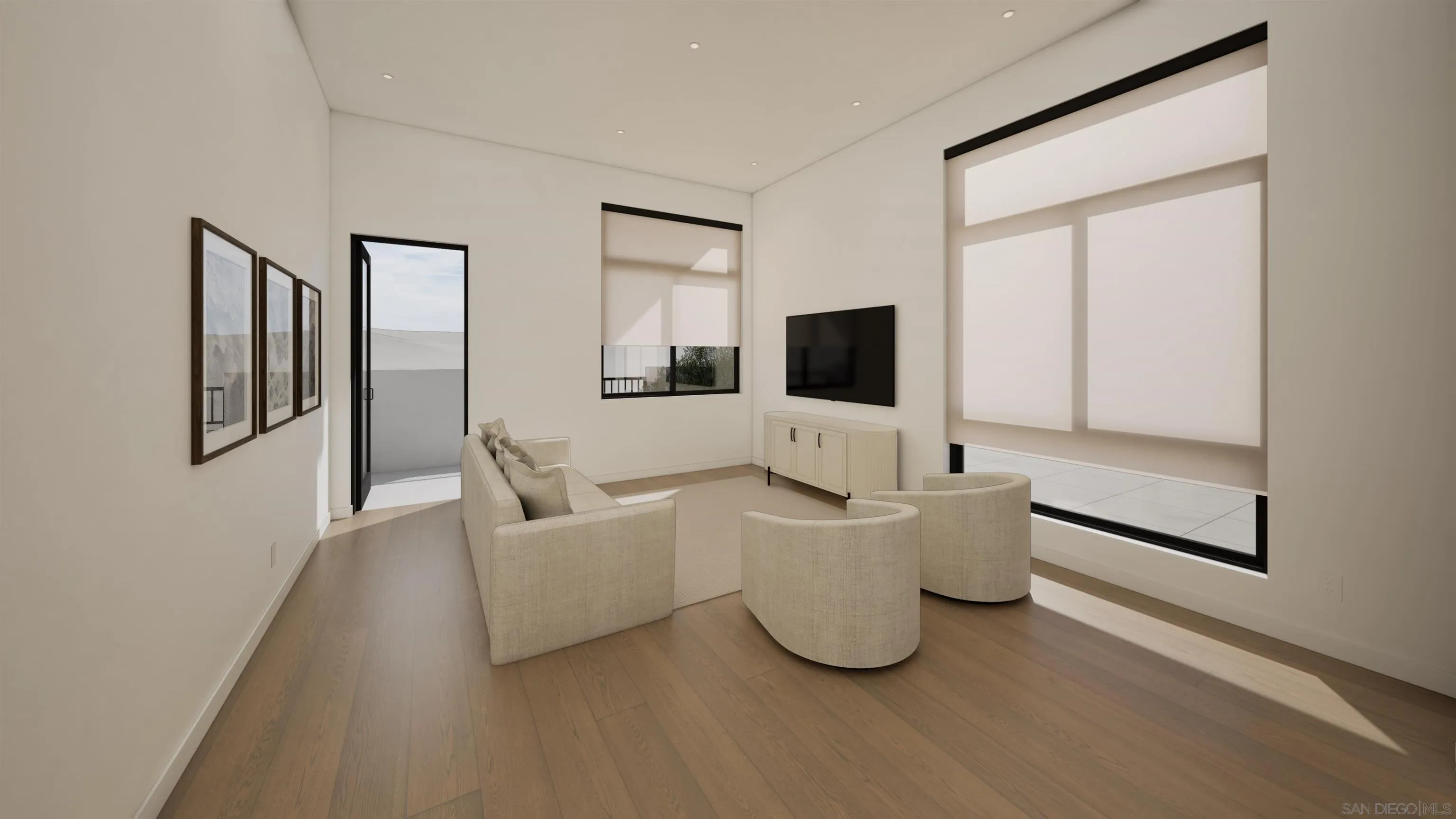 Modern living room with curved chairs, wood floors, and large windows opening onto a terrace.