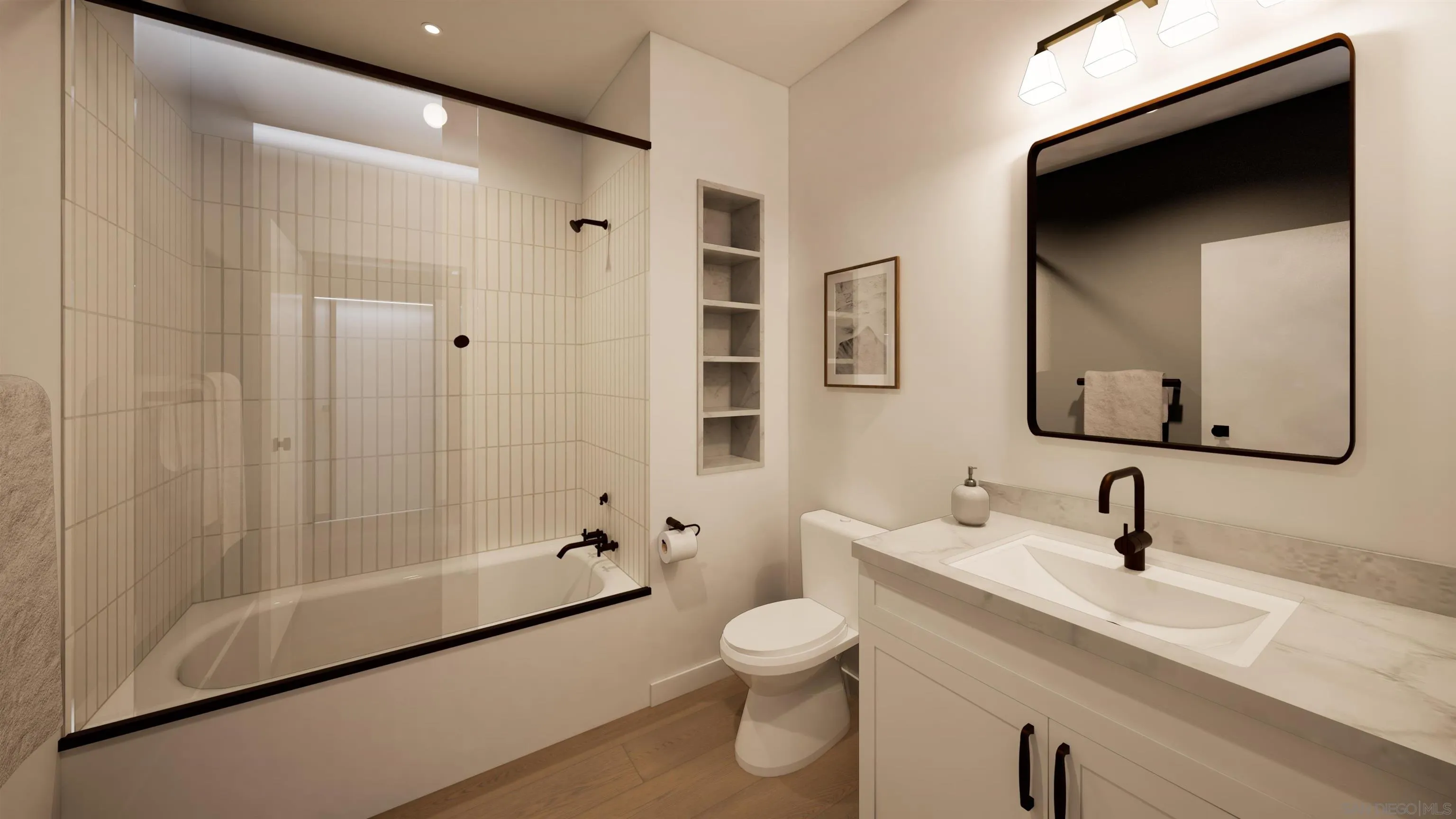 Bathroom with glass-enclosed tub and shower, white vanity, black faucet, and wood flooring.