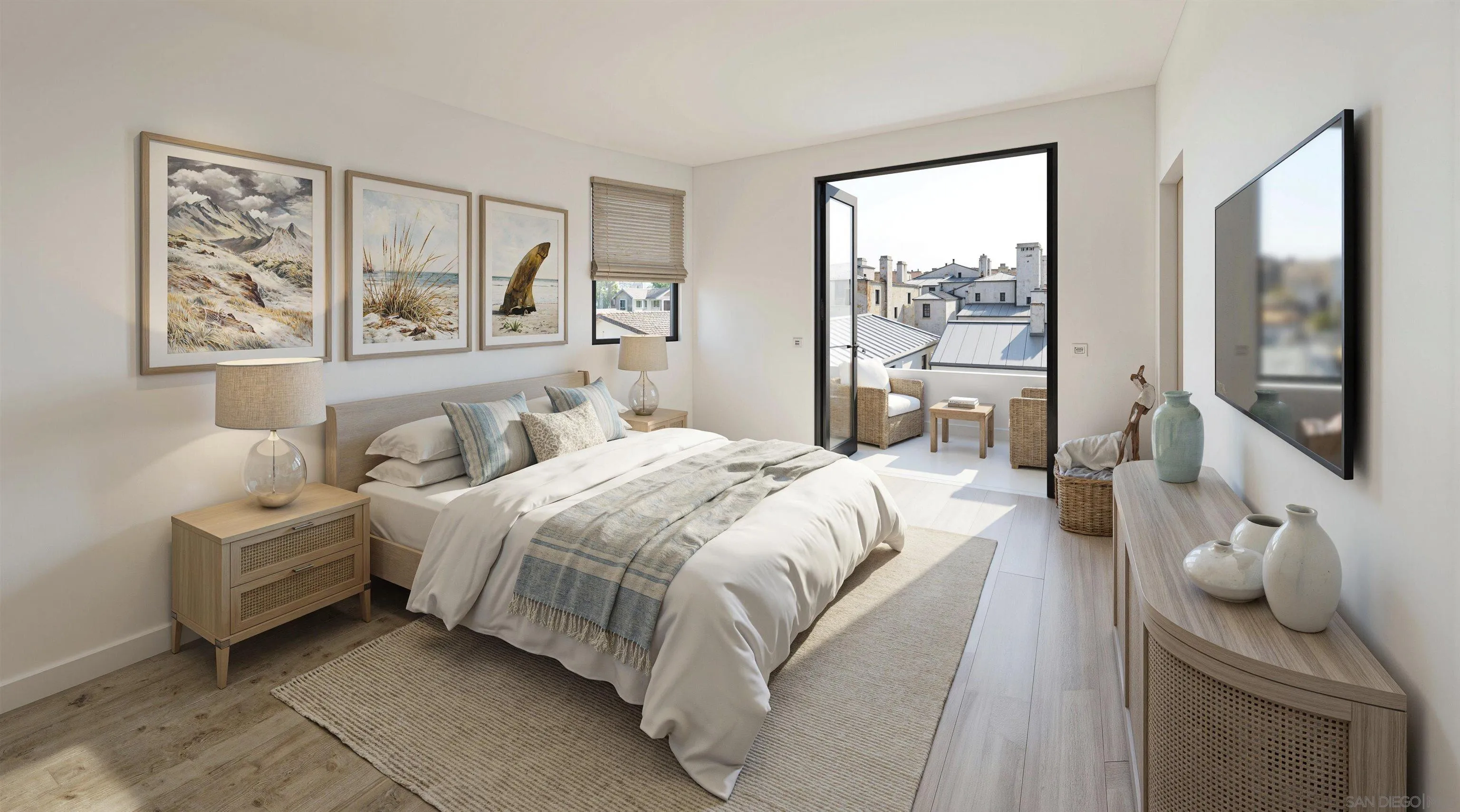 Furnished bedroom with a king bed and open balcony doors overlooking nearby rooftops.