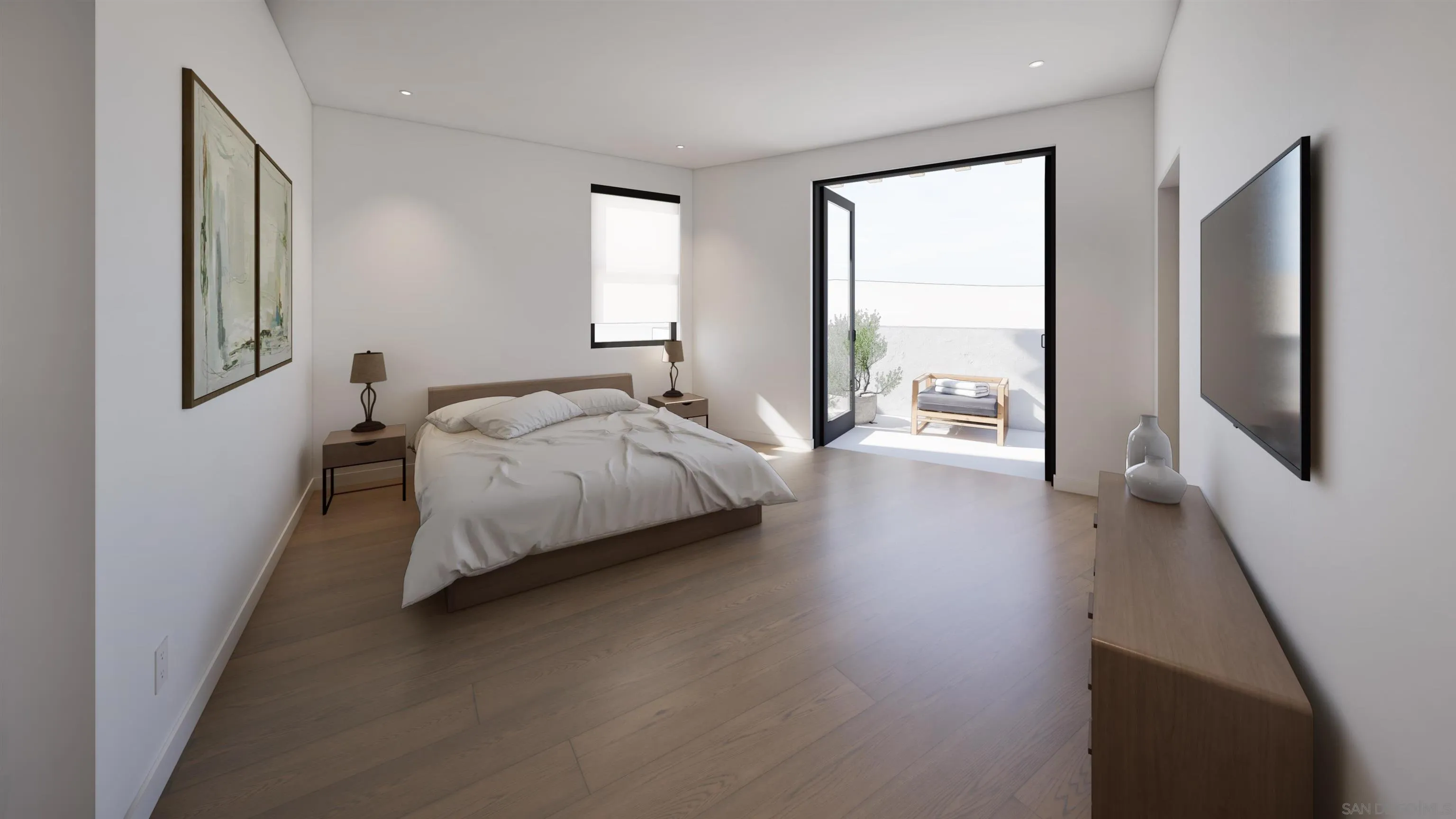 Furnished bedroom with wood floors and glass doors opening onto a sunny patio.