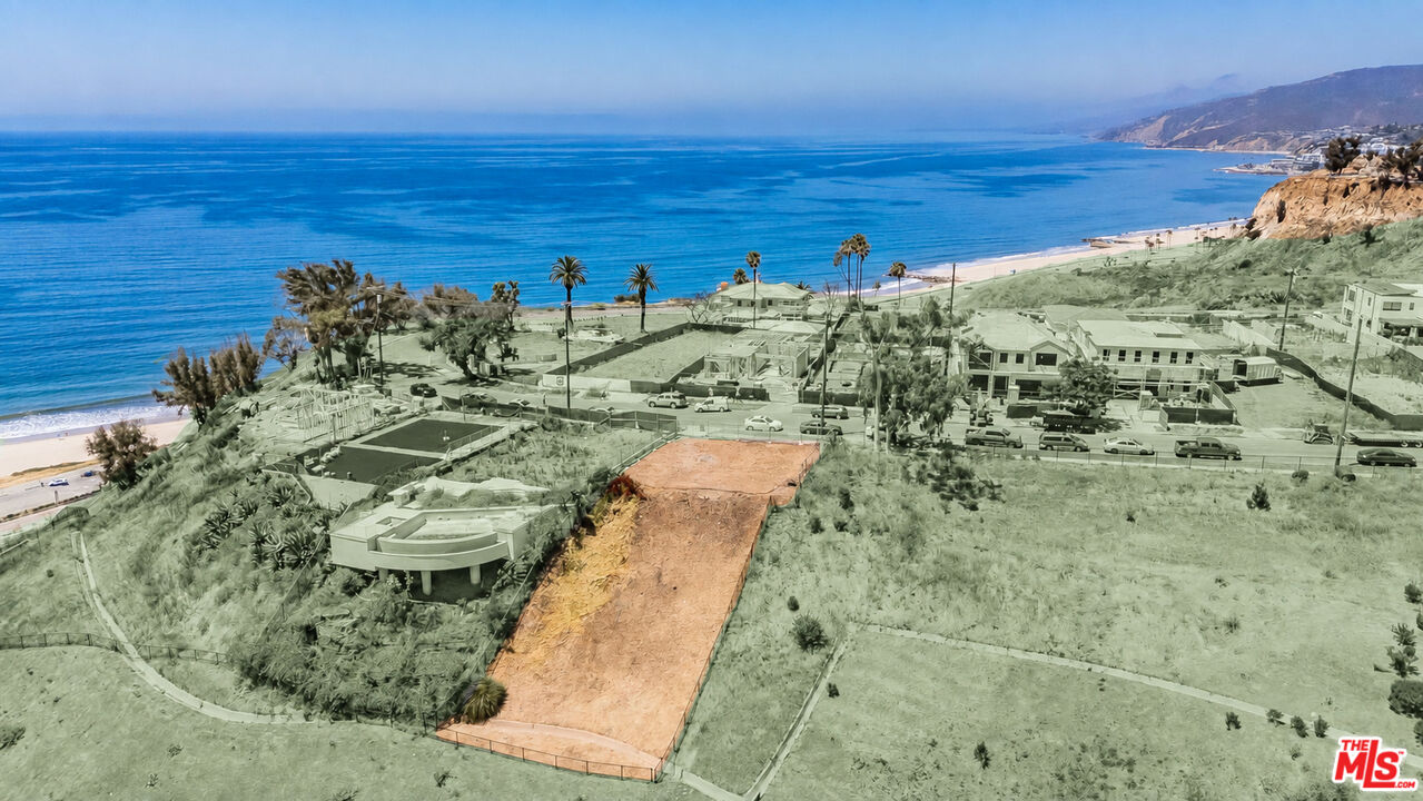 Aerial view of an orange-marked coastal lot with the Pacific Ocean and beach beyond.