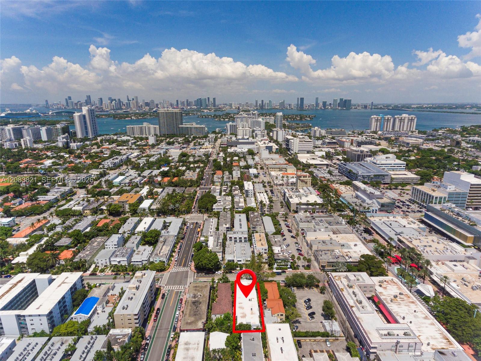 Aerial view of the marked building, with Biscayne Bay and the Miami skyline in the distance.