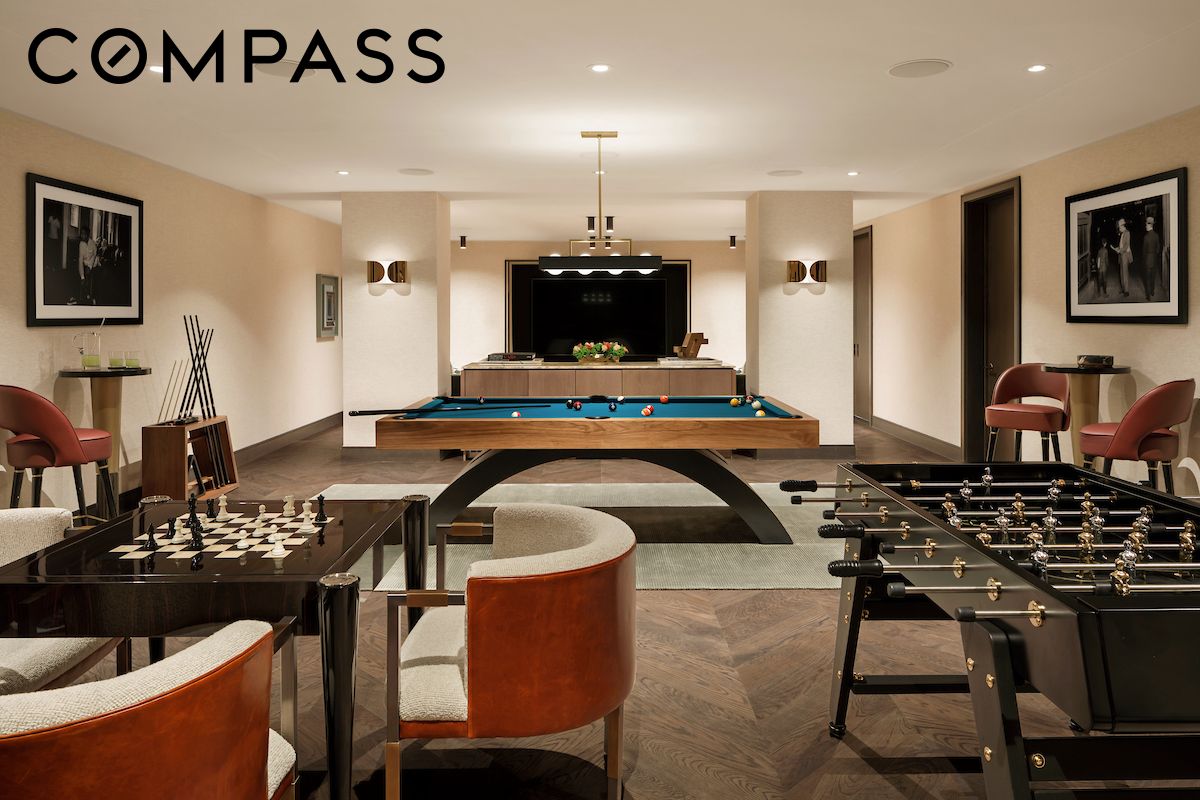 Furnished game room with a pool table, foosball table, chess set, and built-in television.