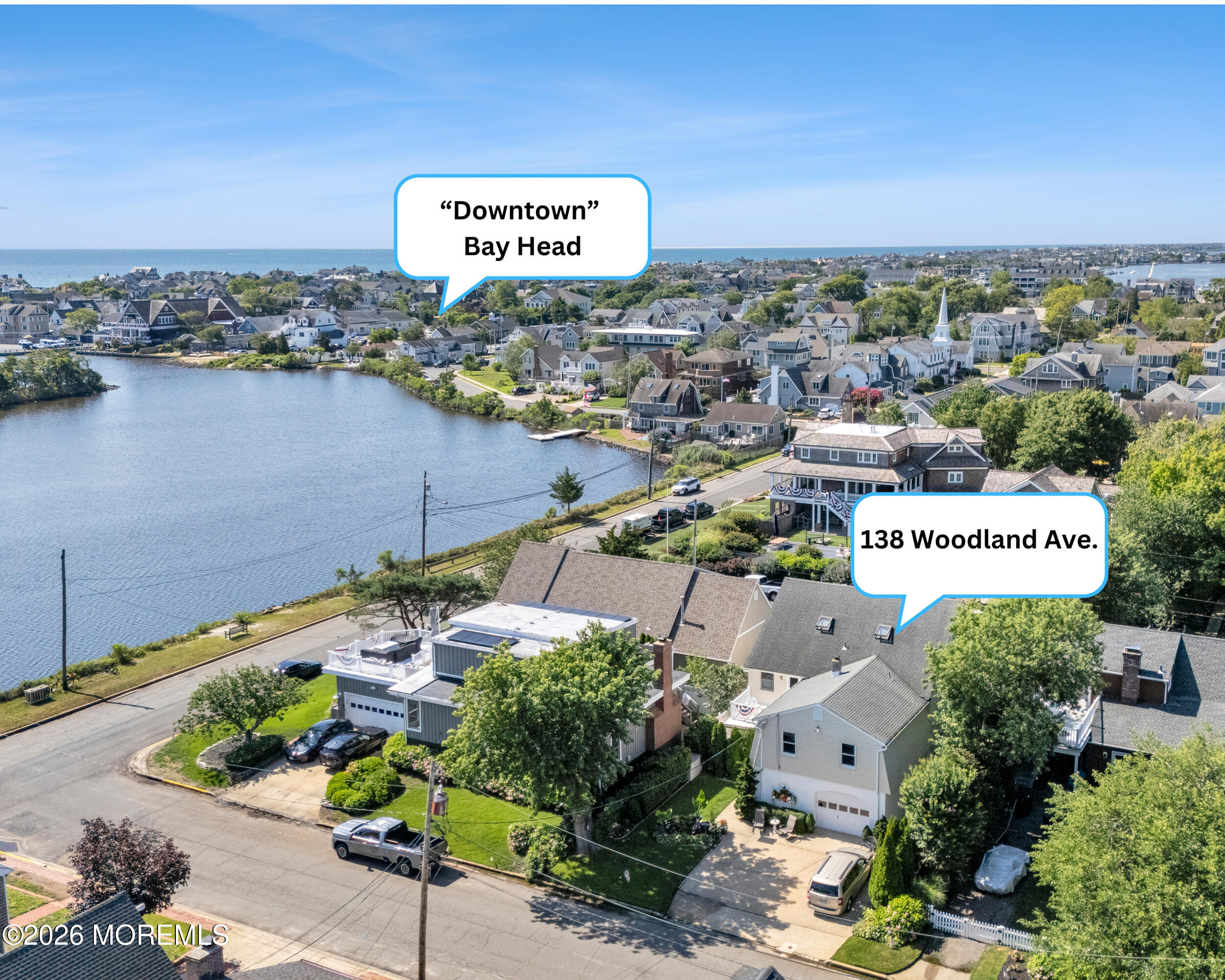 Aerial view of 138 Woodland Avenue in Bay Head, beside a waterway with the ocean in the distance.
