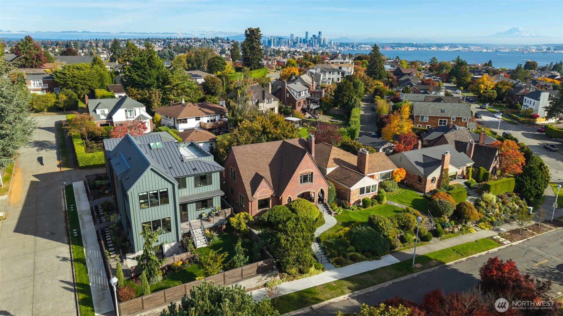 Seattle homes with downtown skyline, Puget Sound, and Mount Rainier in the distance.