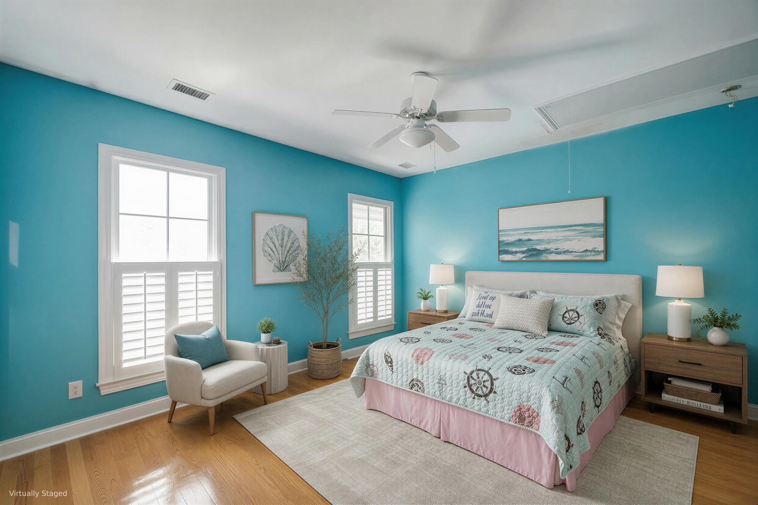Staged bedroom with turquoise walls, a large bed, white plantation shutters, and hardwood floors.