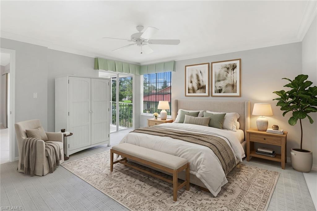Staged bedroom with a king-size bed, patterned rug, and glass door to a balcony.