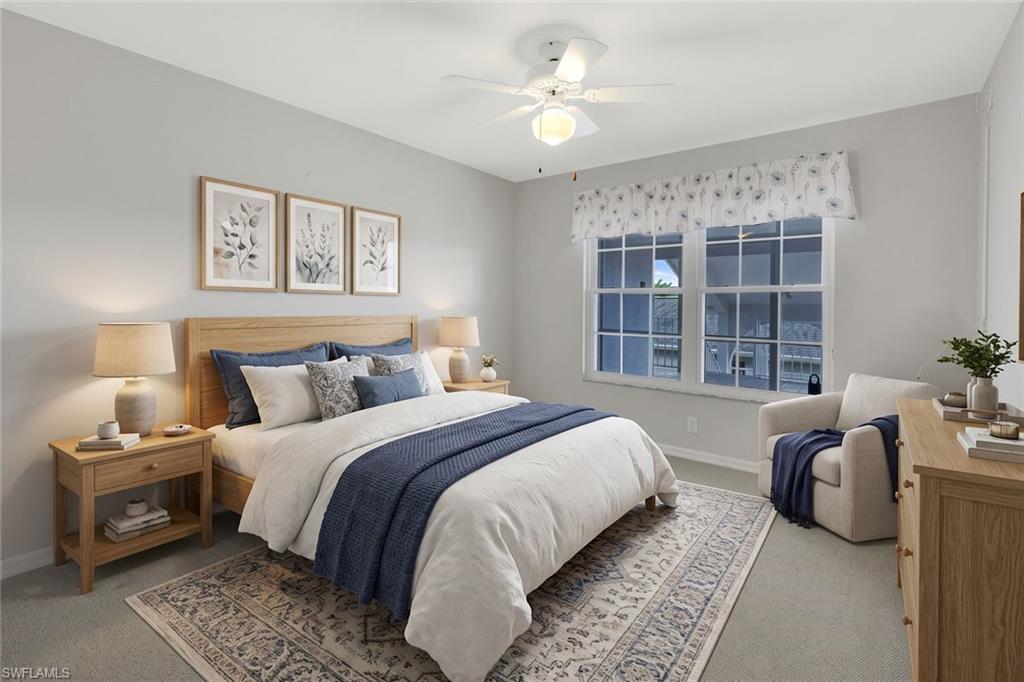 Staged bedroom with blue-and-white bedding, light wood furniture, and a large window.