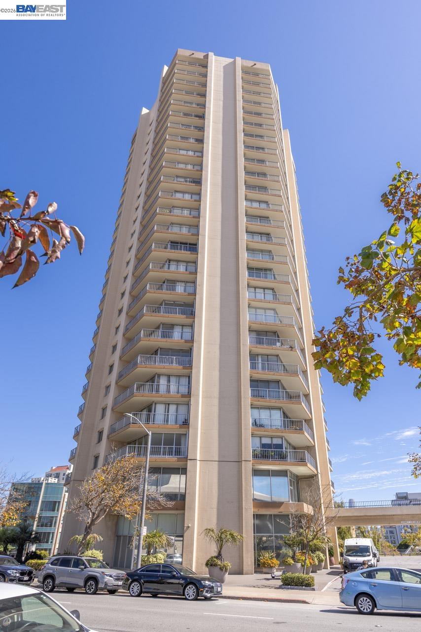 Residential tower at 1200 Gough St, with stacked balconies and a landscaped entrance.