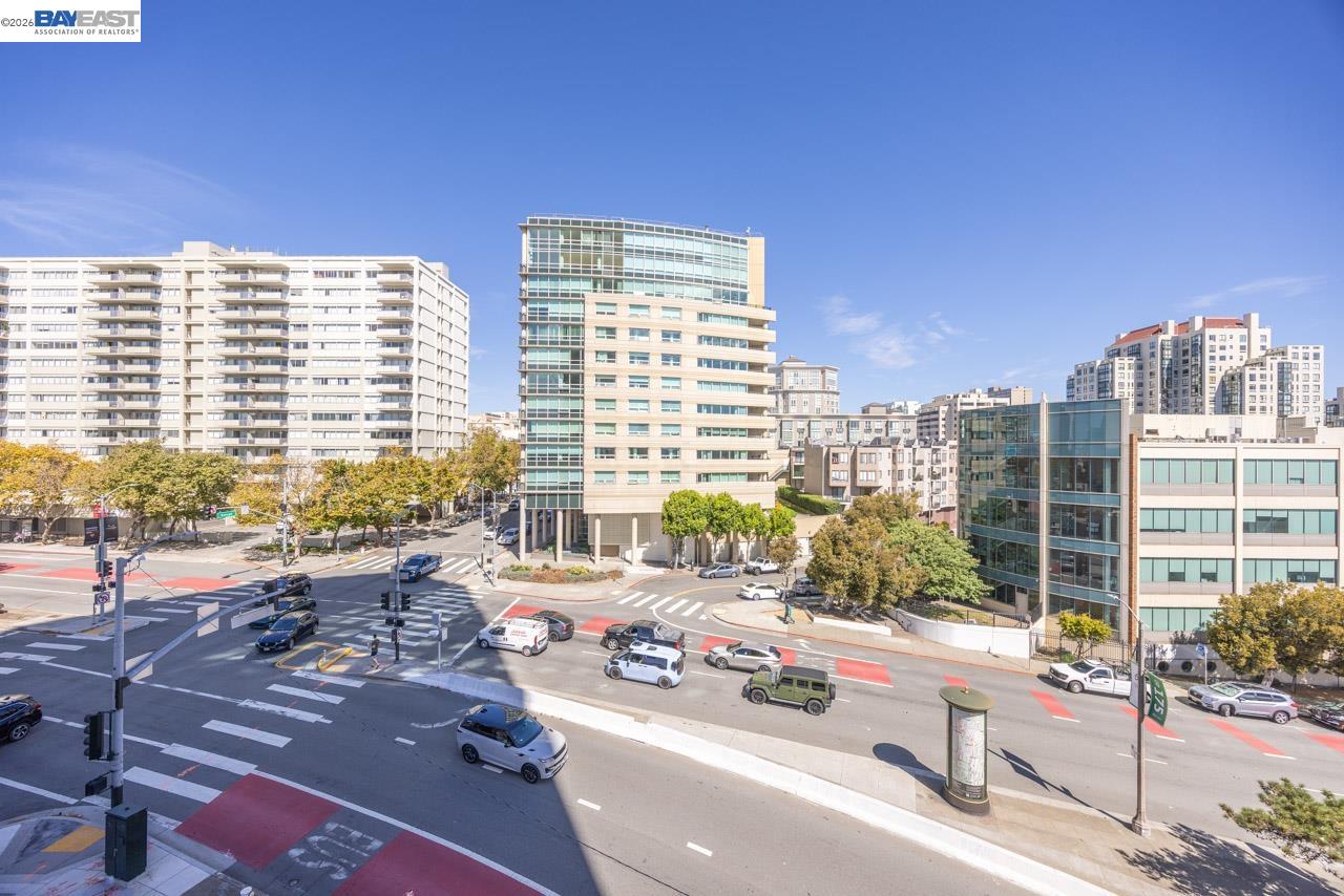 City view overlooking San Francisco buildings and a busy intersection.