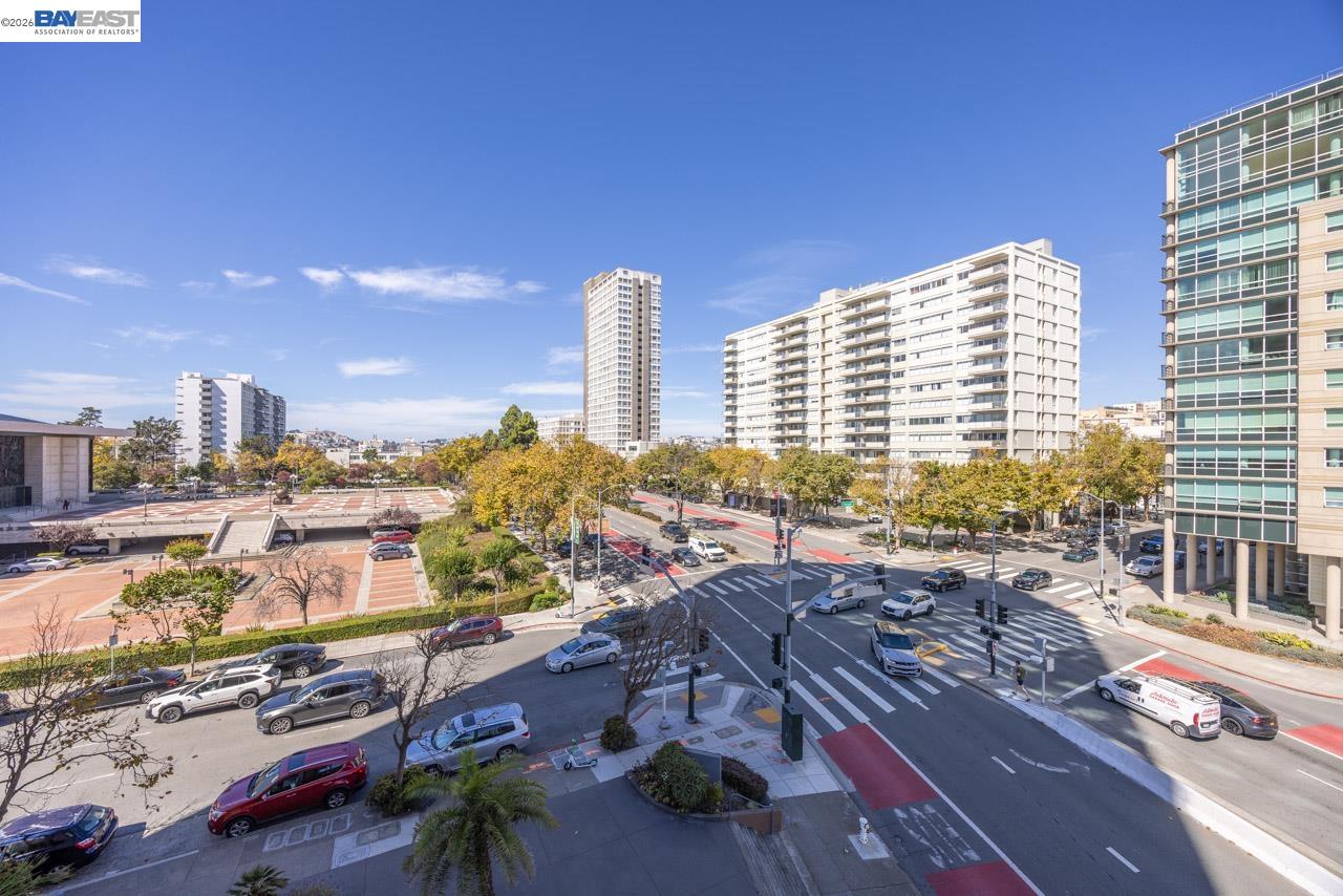 San Francisco city view over a busy intersection, with high-rise buildings and tree-lined streets.