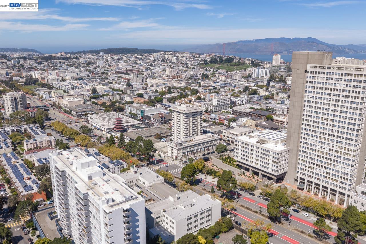 Aerial panorama of San Francisco with the Golden Gate Bridge and bay in the distance.