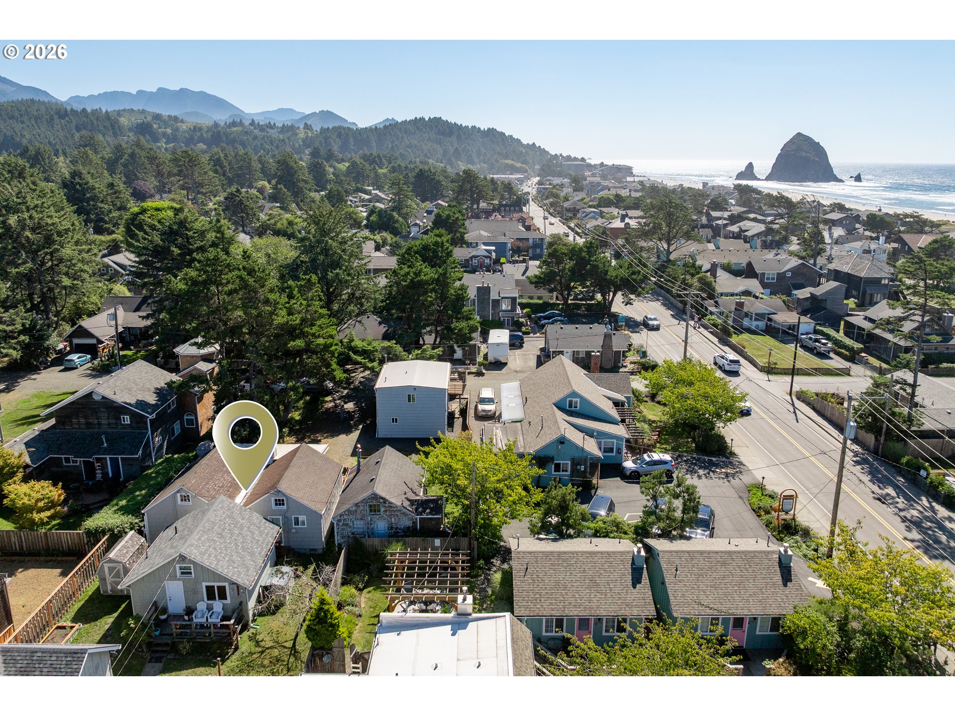 Aerial view of the marked Cannon Beach home, with the Pacific Ocean and Haystack Rock beyond.