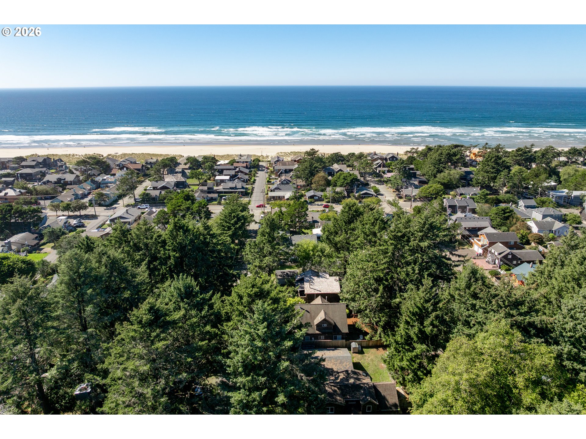 Aerial view of a Cannon Beach neighborhood, beach, and Pacific Ocean.