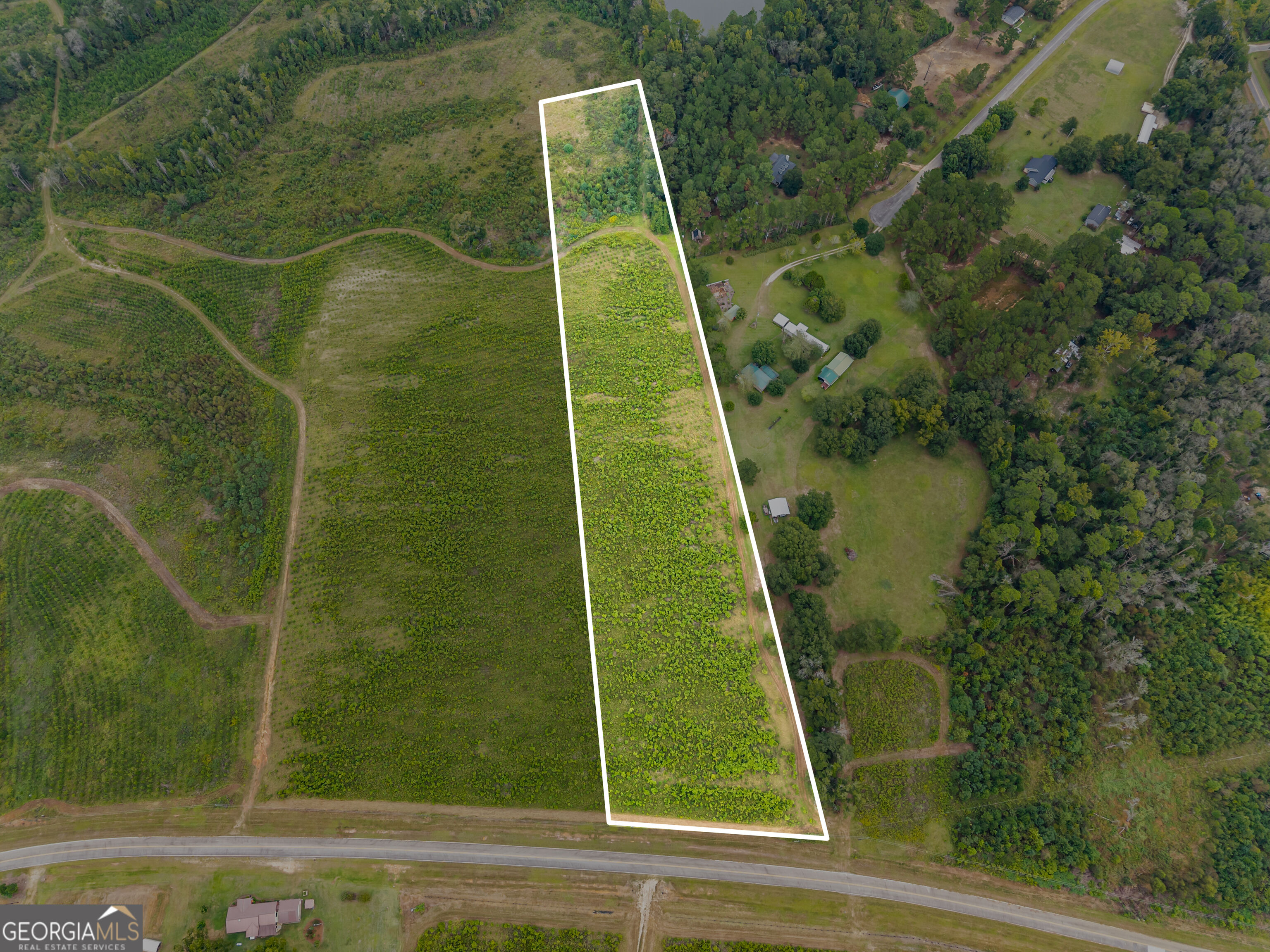 Aerial view of the long, white-outlined rural parcel at 0 G W Oliver Rd, beside a paved road.