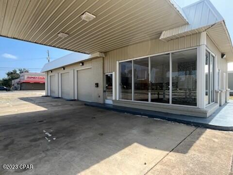 Single-story commercial building with a broad covered canopy and large front windows.