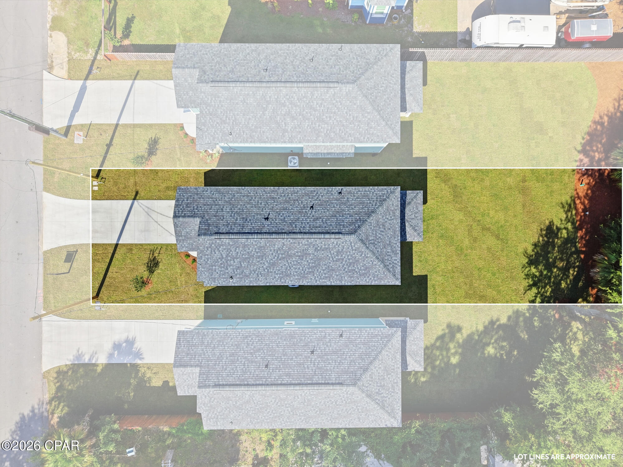 Aerial view of a house and lawn outlined by approximate lot lines.