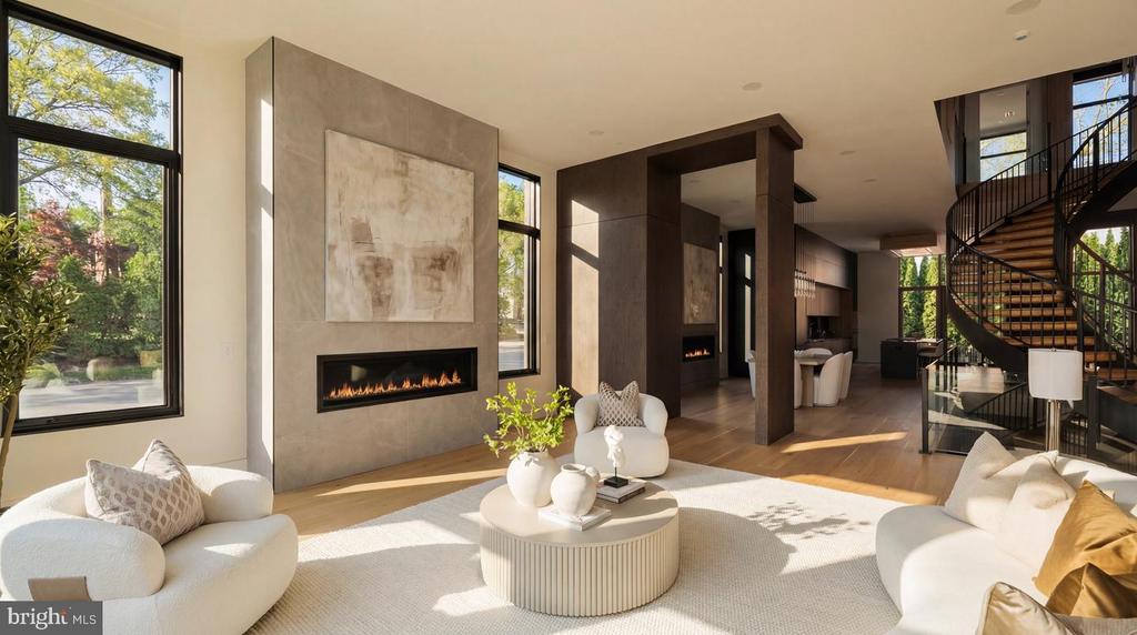 Contemporary living room with a linear fireplace, white seating, and a curved staircase.