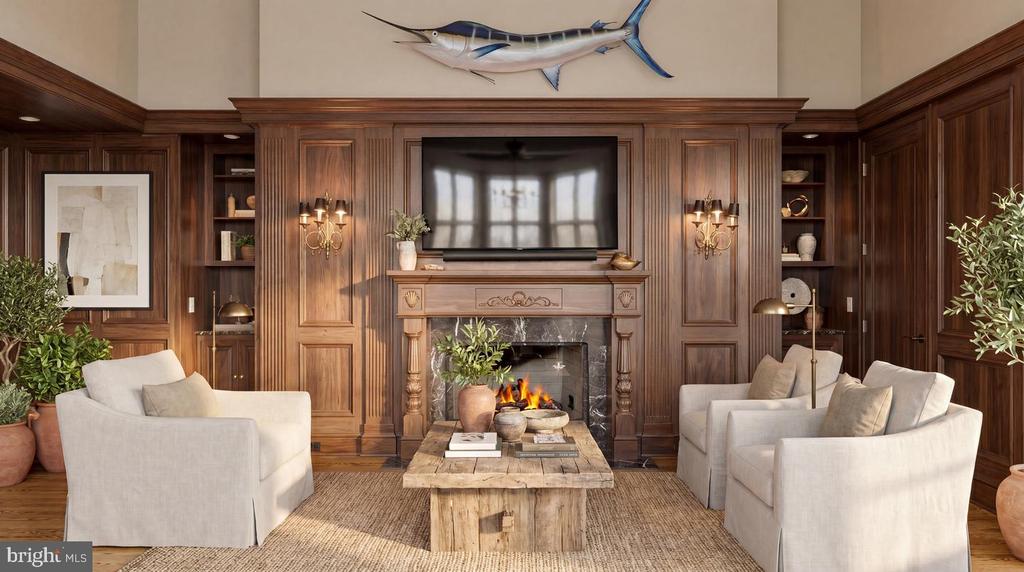 Living room with wood-paneled walls, a fireplace, built-in shelving, and light upholstered seating.