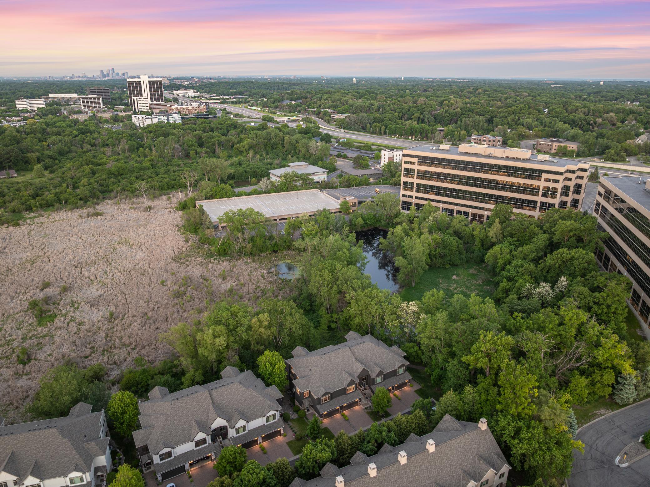 Upscale end unit with main-floor living, a private elevator, walkable to shopping and restaurants
