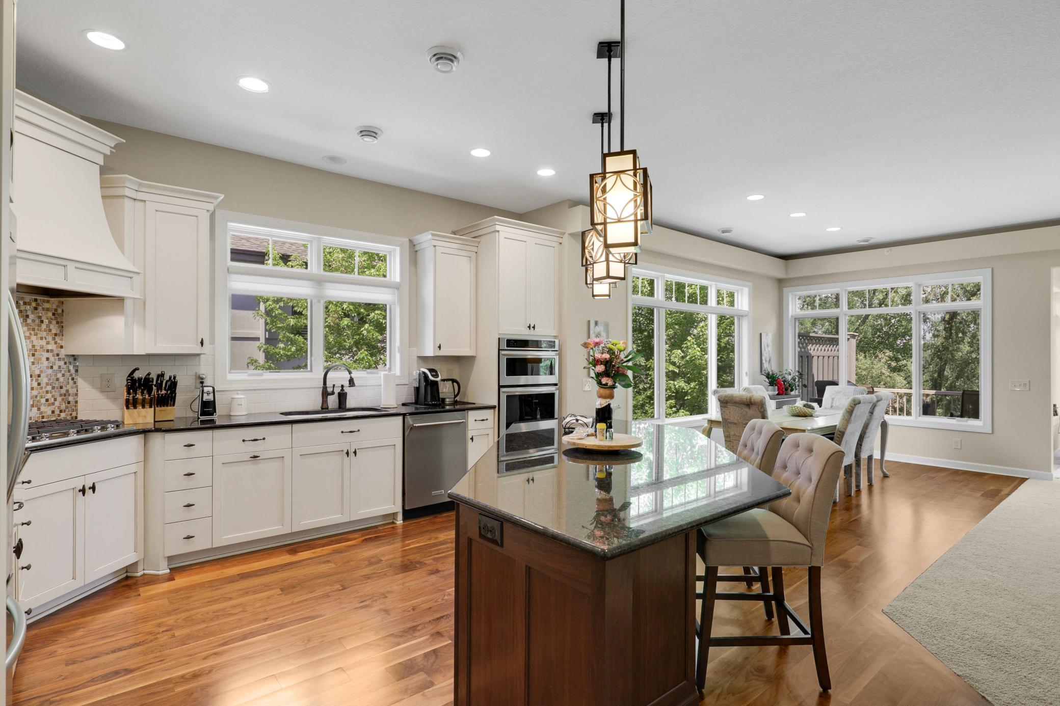 Upscale end unit with main-floor living, a private elevator, walkable to shopping and restaurants