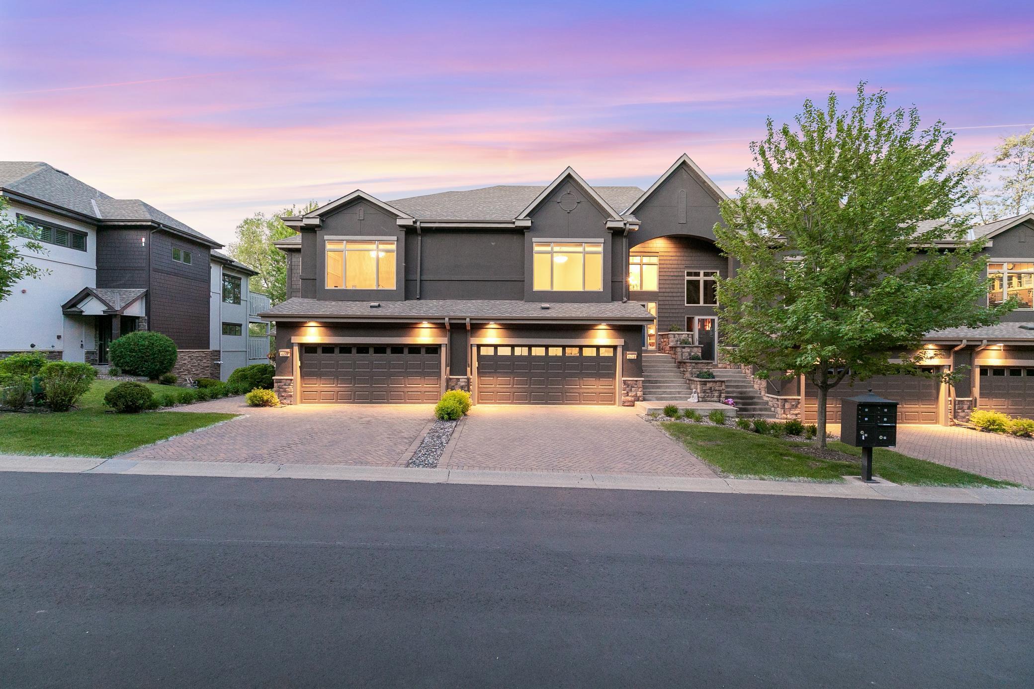 Upscale end unit with main-floor living, a private elevator, walkable to shopping and restaurants