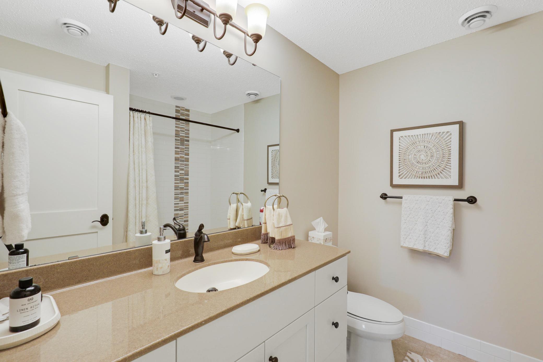 Upscale end unit with main-floor living, a private elevator, walkable to shopping and restaurants