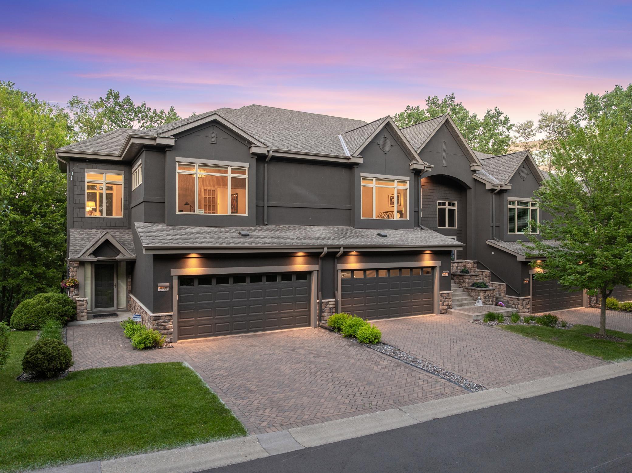 Upscale end unit with main-floor living, a private elevator, walkable to shopping and restaurants