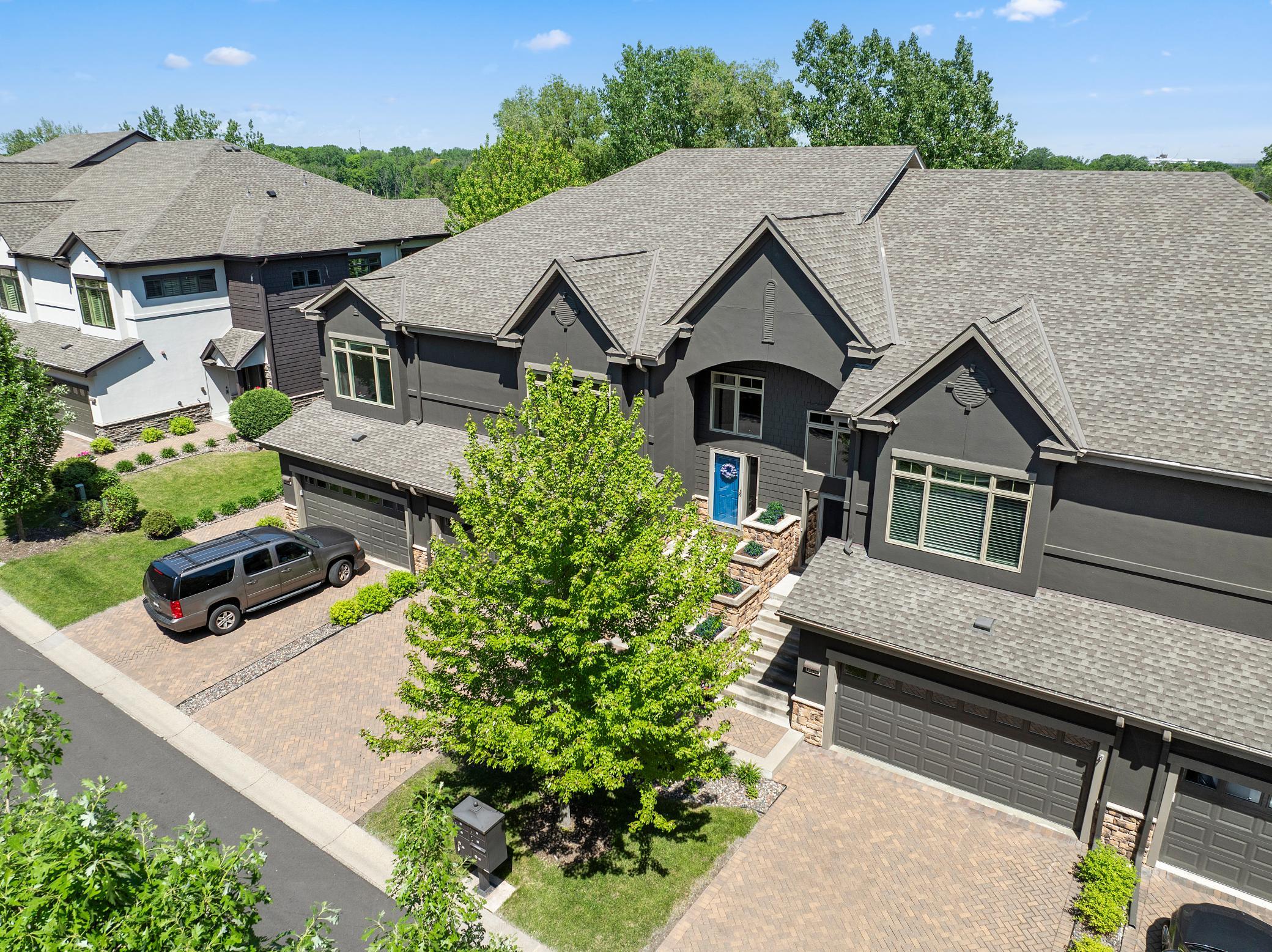 Upscale end unit with main-floor living, a private elevator, walkable to shopping and restaurants