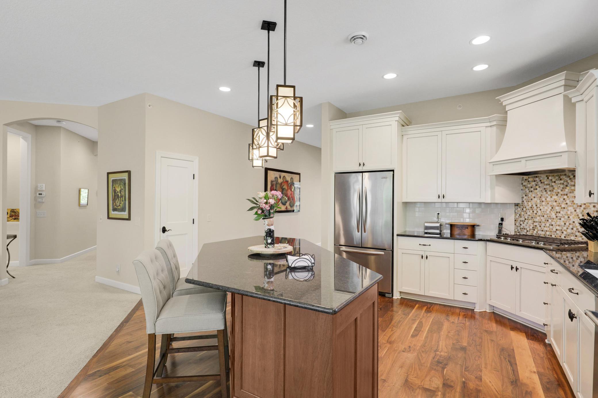 Upscale end unit with main-floor living, a private elevator, walkable to shopping and restaurants