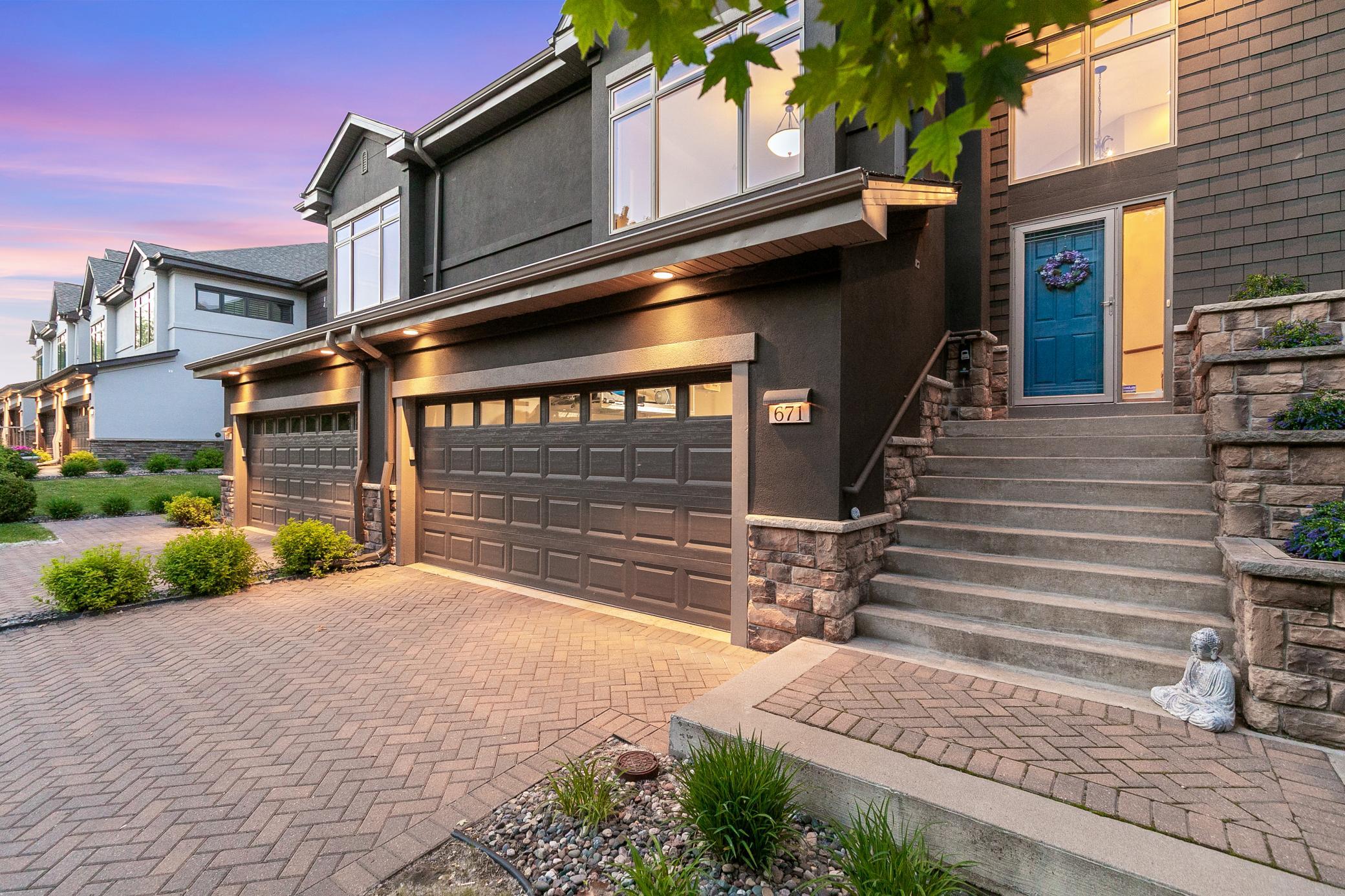 Upscale end unit with main-floor living, a private elevator, walkable to shopping and restaurants