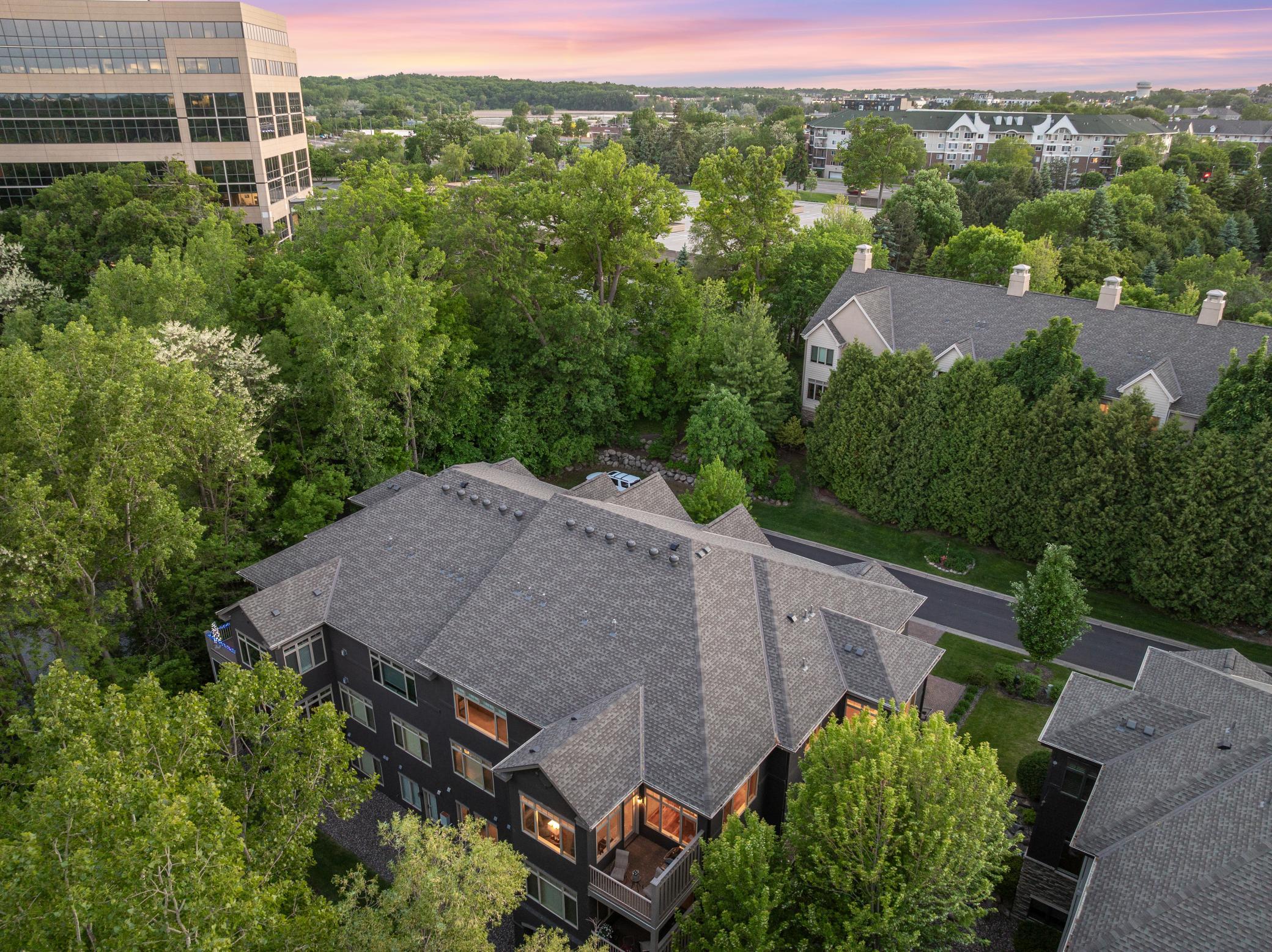 Upscale end unit with main-floor living, a private elevator, walkable to shopping and restaurants