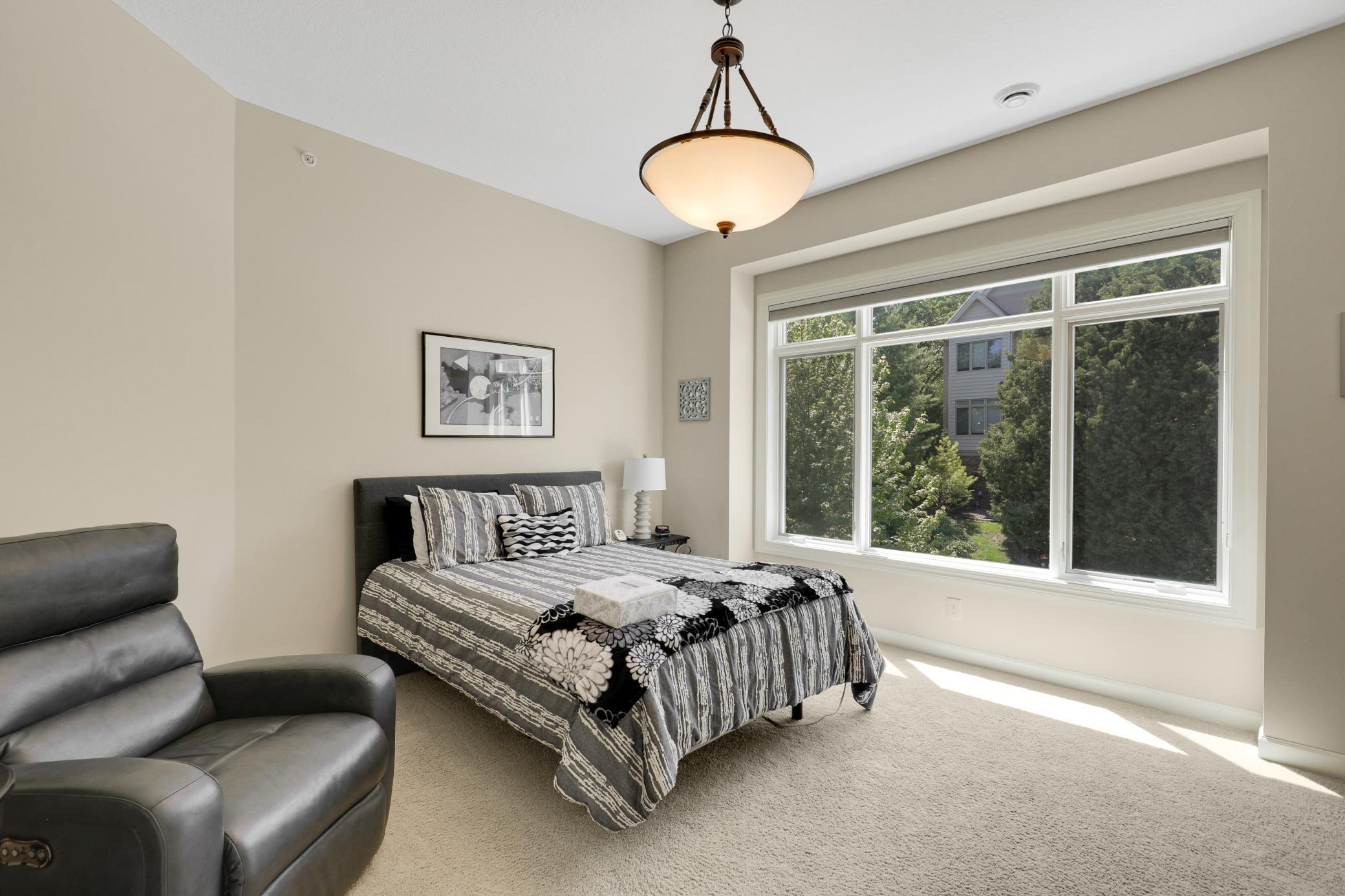 Upscale end unit with main-floor living, a private elevator, walkable to shopping and restaurants