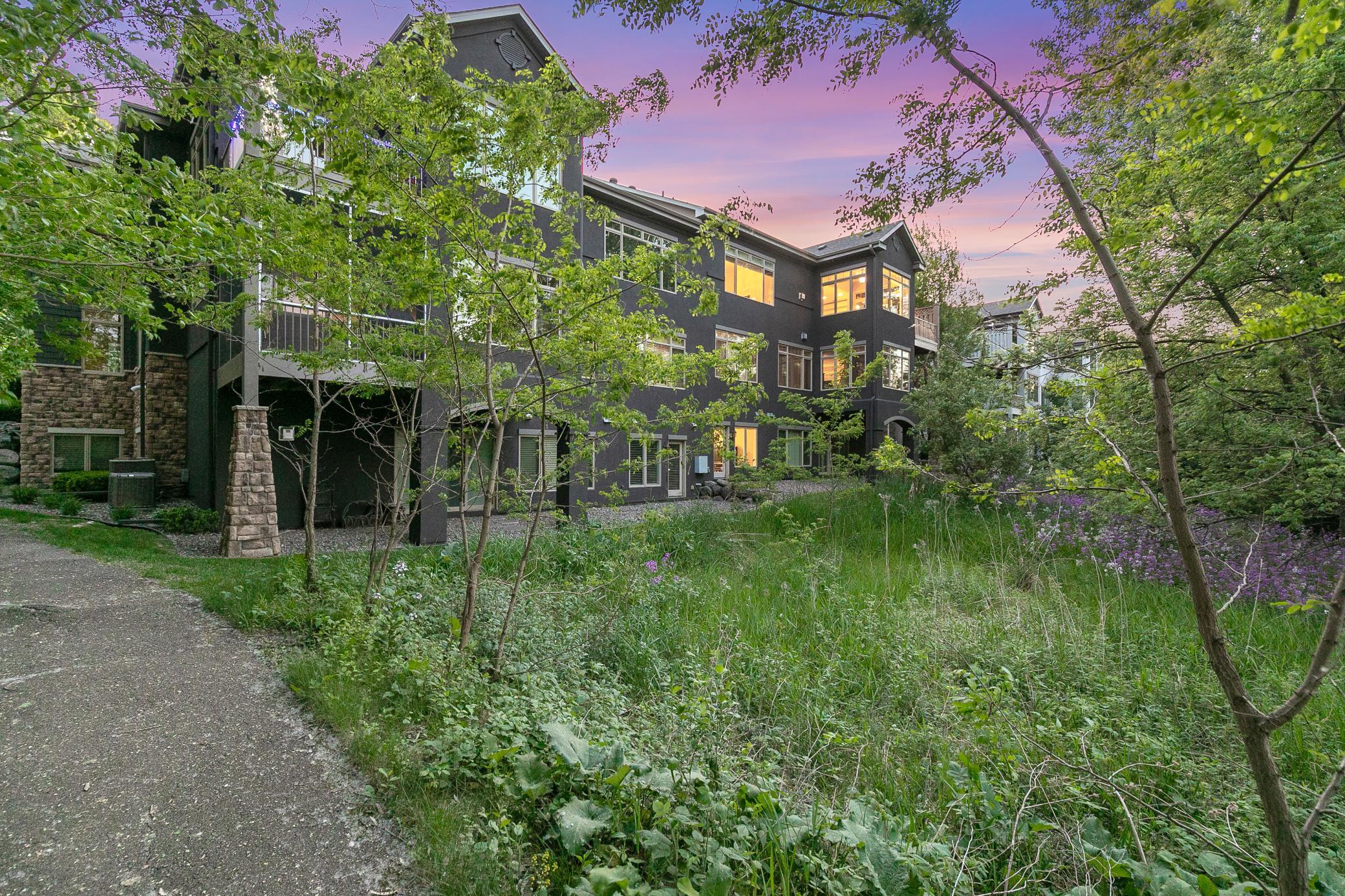Upscale end unit with main-floor living, a private elevator, walkable to shopping and restaurants
