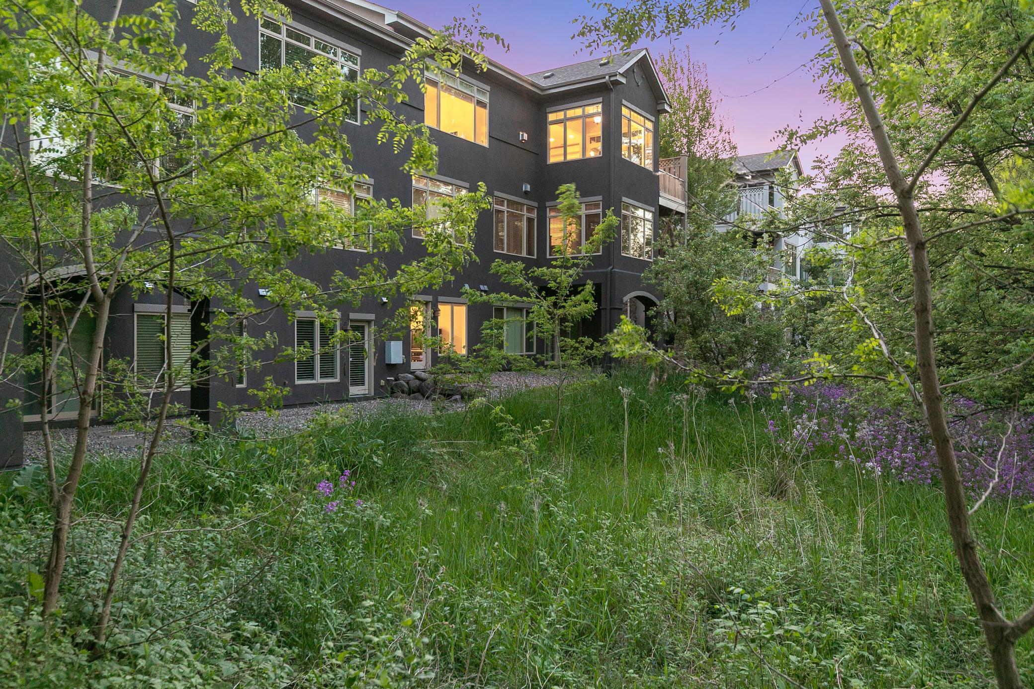 Upscale end unit with main-floor living, a private elevator, walkable to shopping and restaurants
