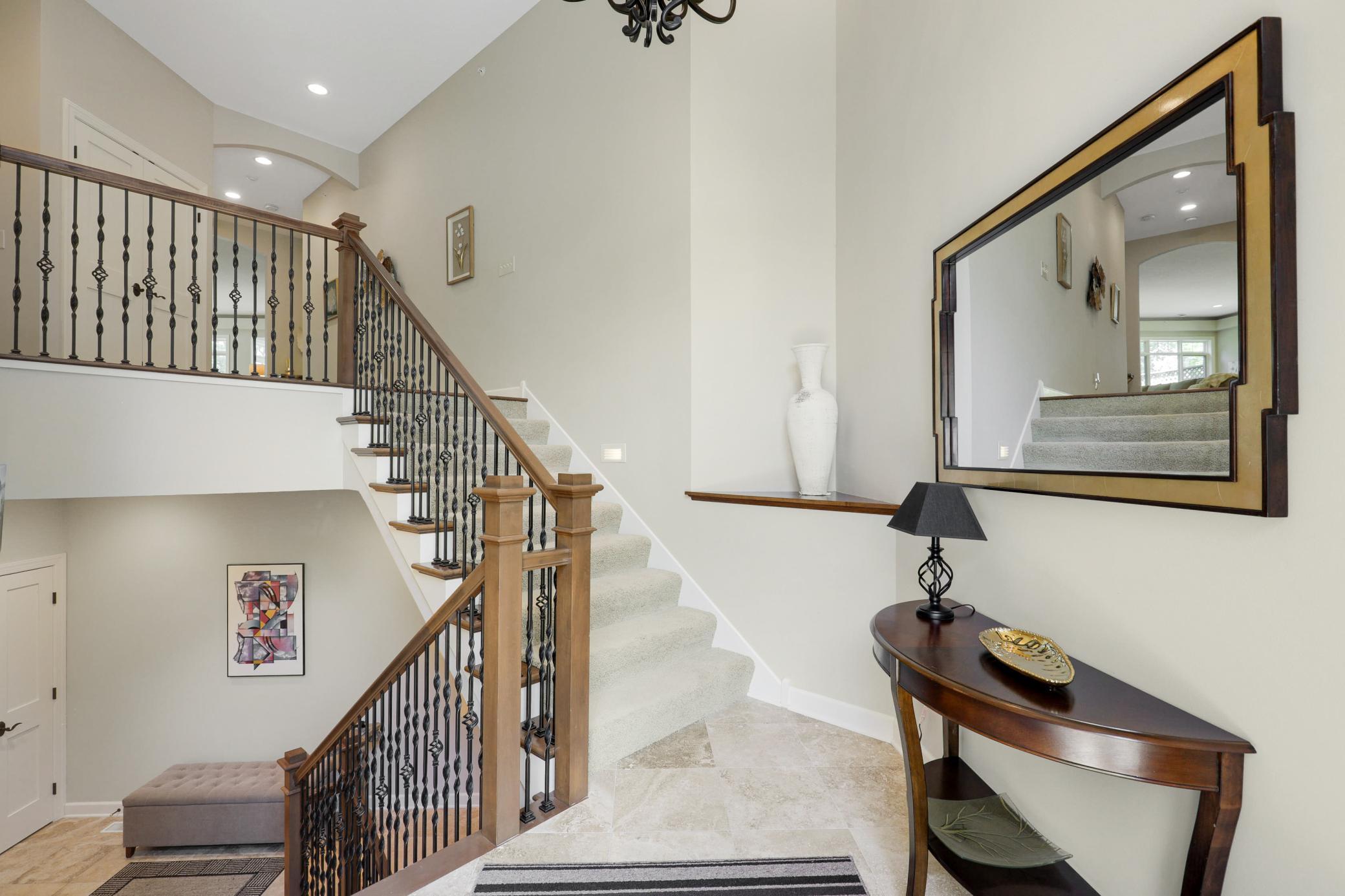 Upscale end unit with main-floor living, a private elevator, walkable to shopping and restaurants