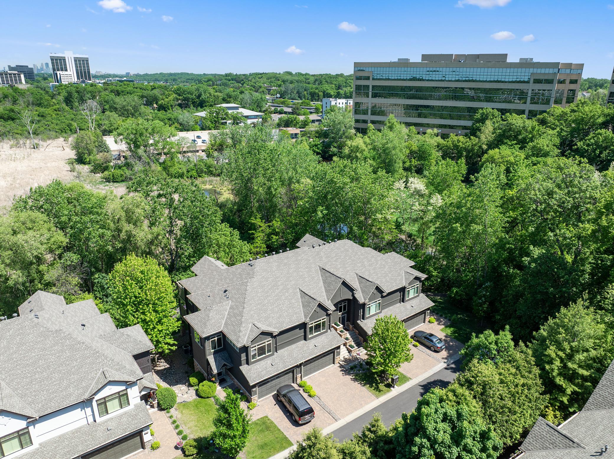 Upscale end unit with main-floor living, a private elevator, walkable to shopping and restaurants